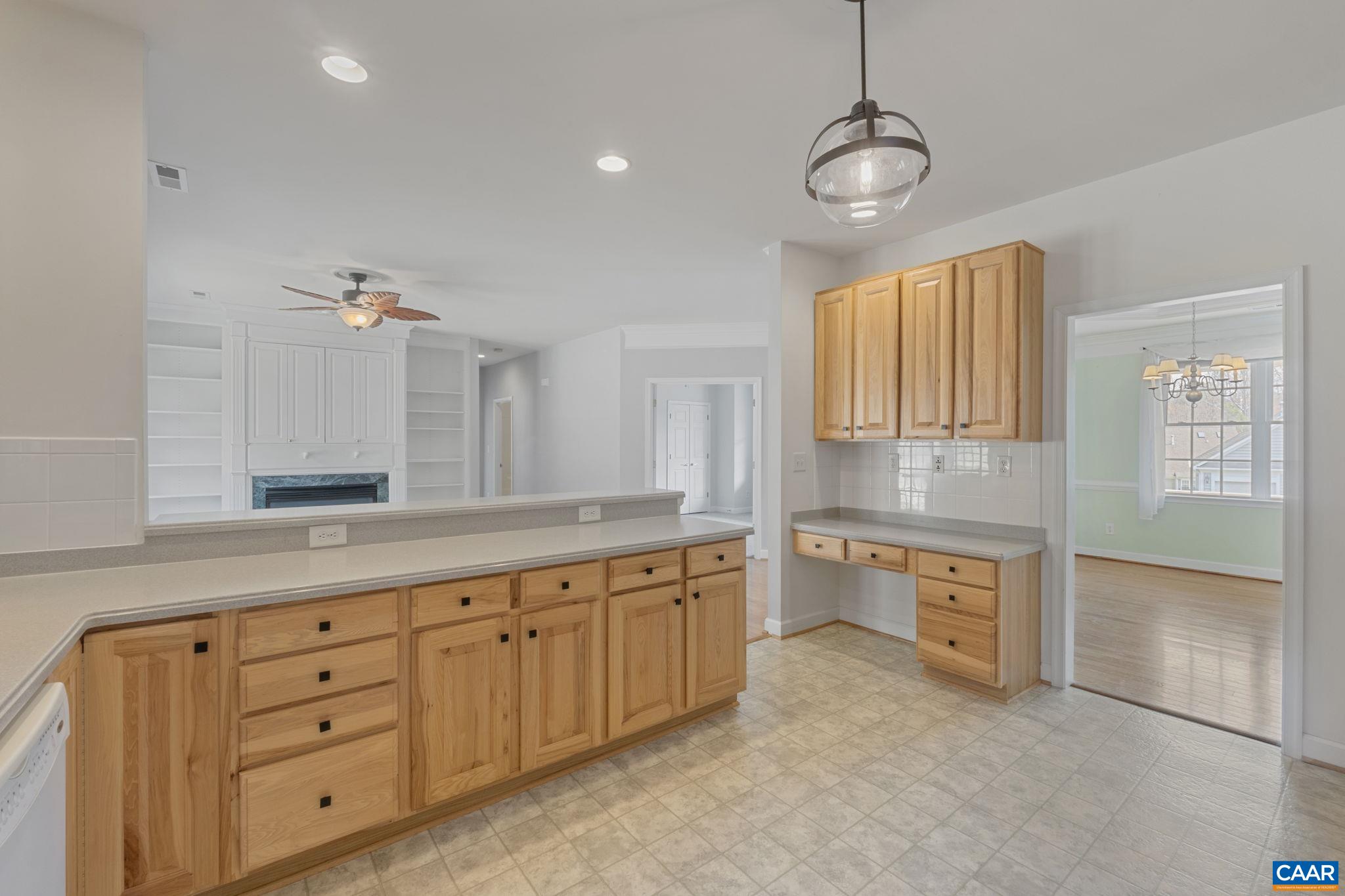 Kitchen with breakfast bar looking into the family room, and handy kitchen desk.