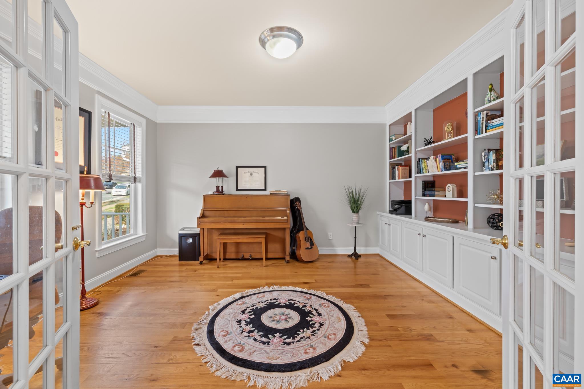 A dedicated main-level study with glass French doors, perfect for a quiet home office.