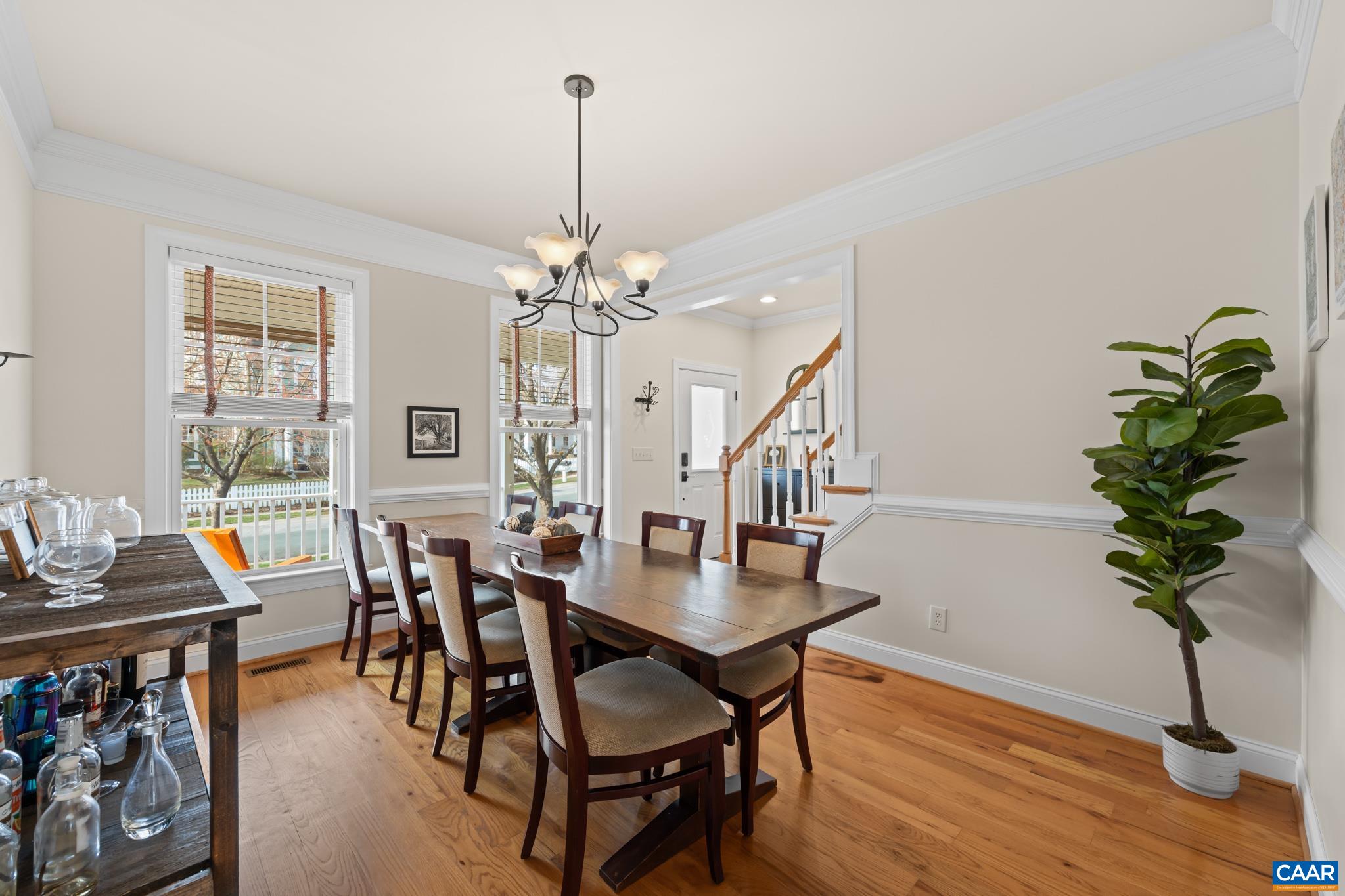Elegant formal dining area with crown molding and easy access to the kitchen.