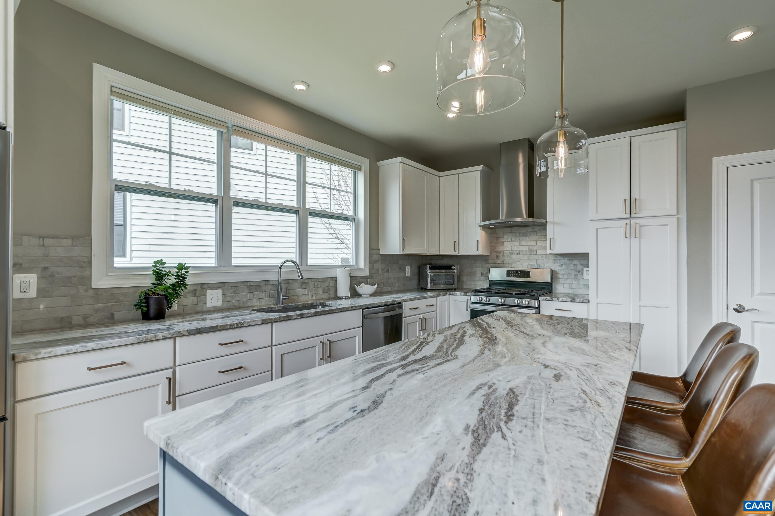 Stainless steel appliances in the open kitchen.