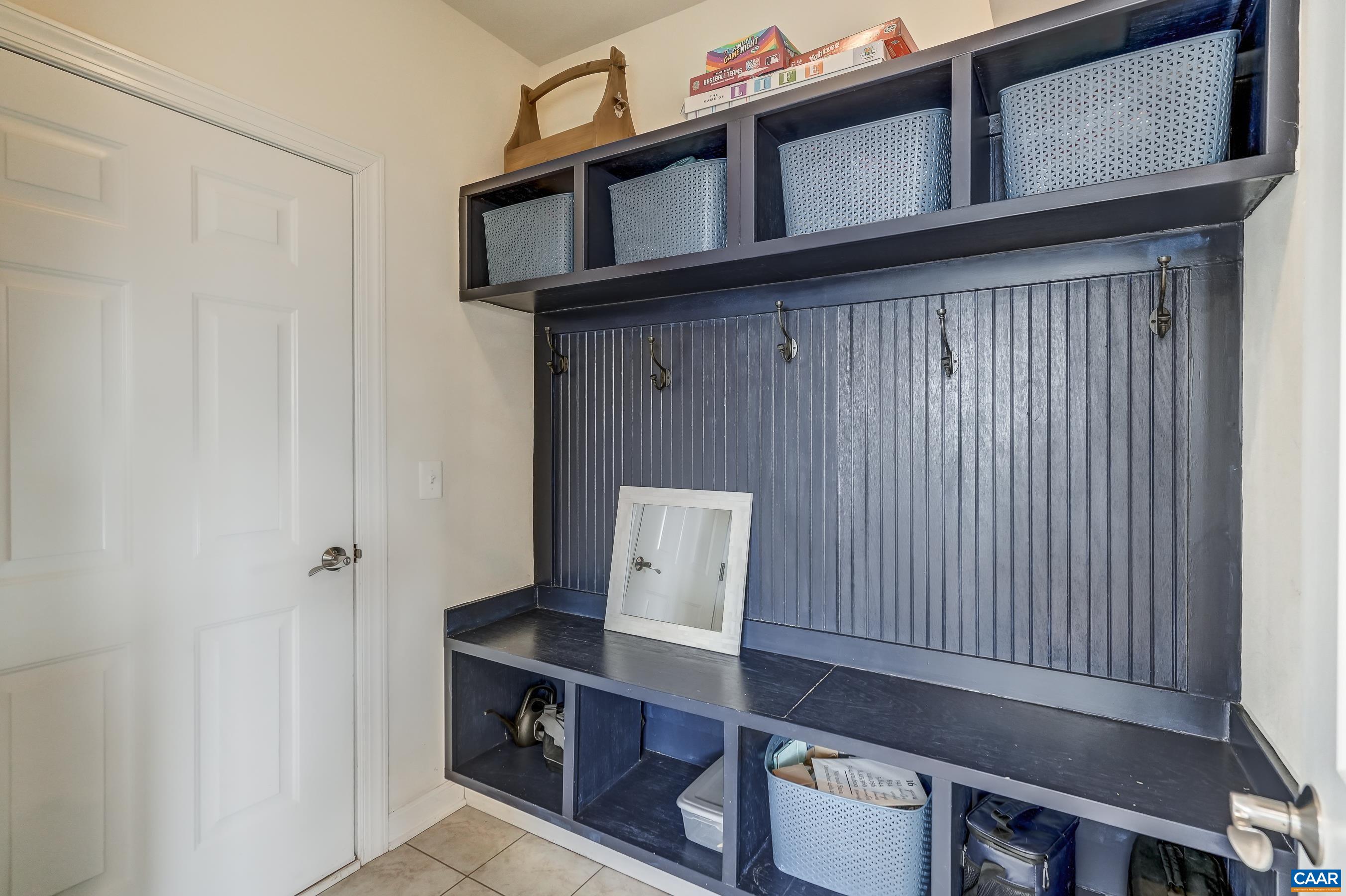 Mudroom features built-in bench with storage cubbies.