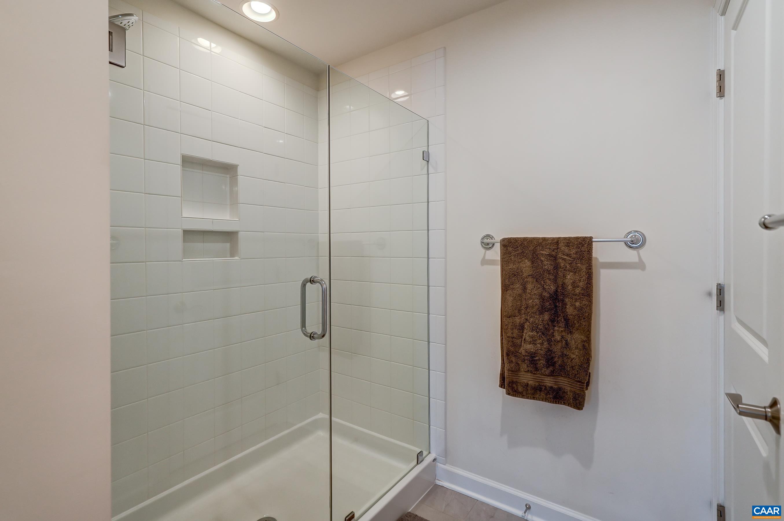 Frameless glass shower in primary bathroom.