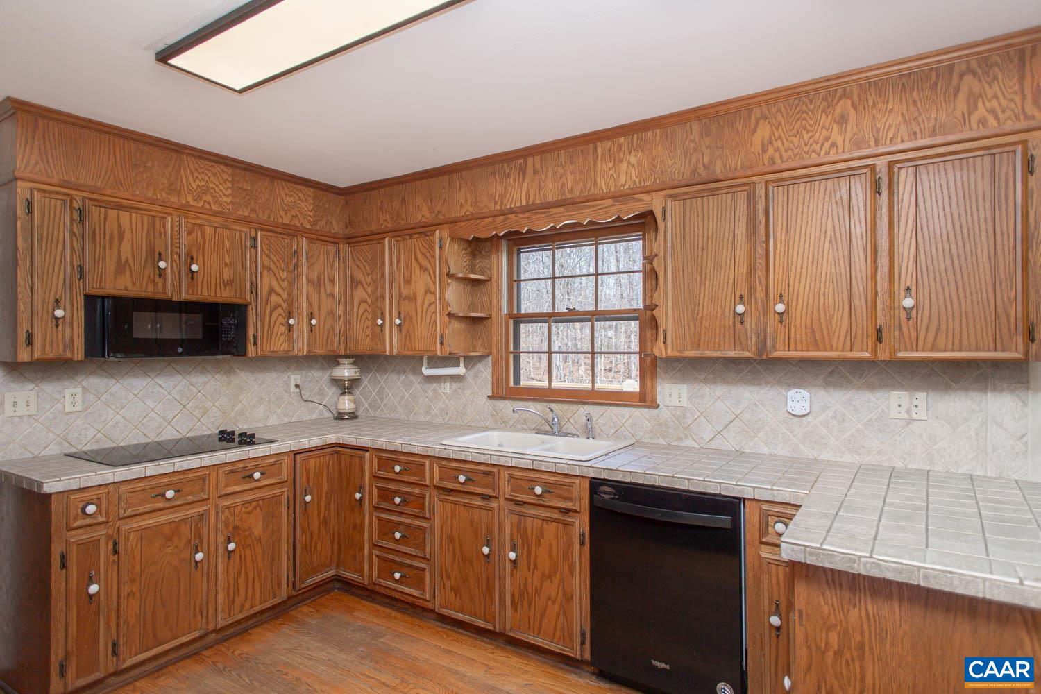 Cabinet-lined eat-in kitchen.