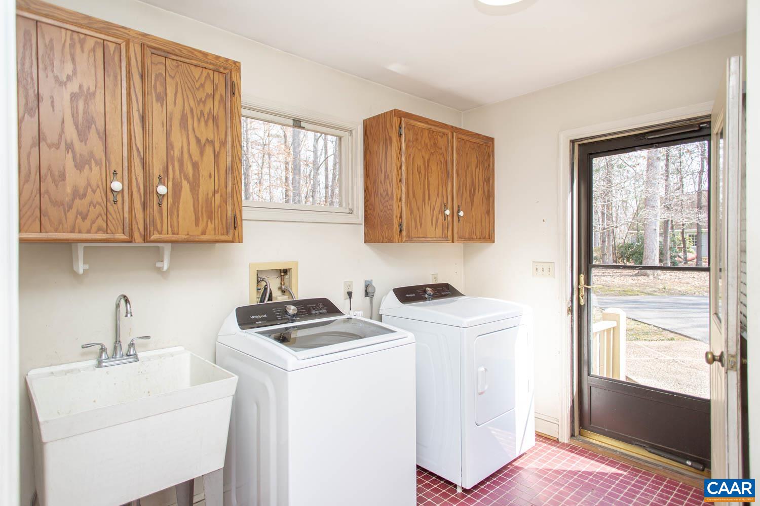 Laundry room/mud room with side entrance to the home.