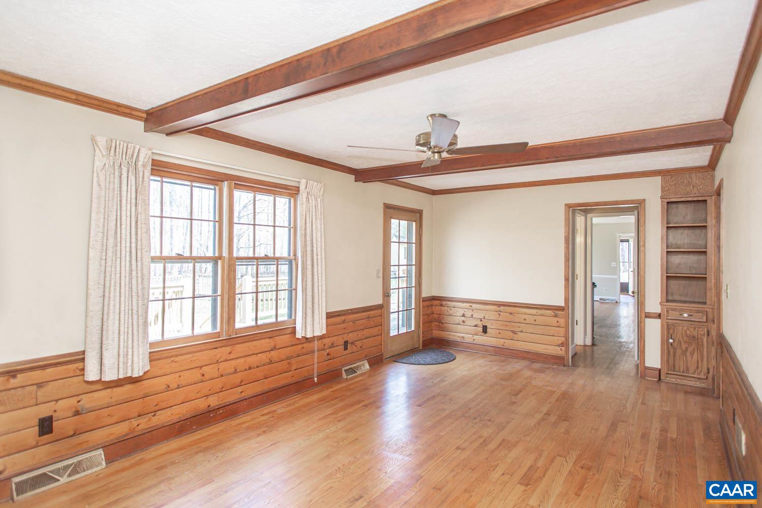 Wood-lined family room with access to the back deck.