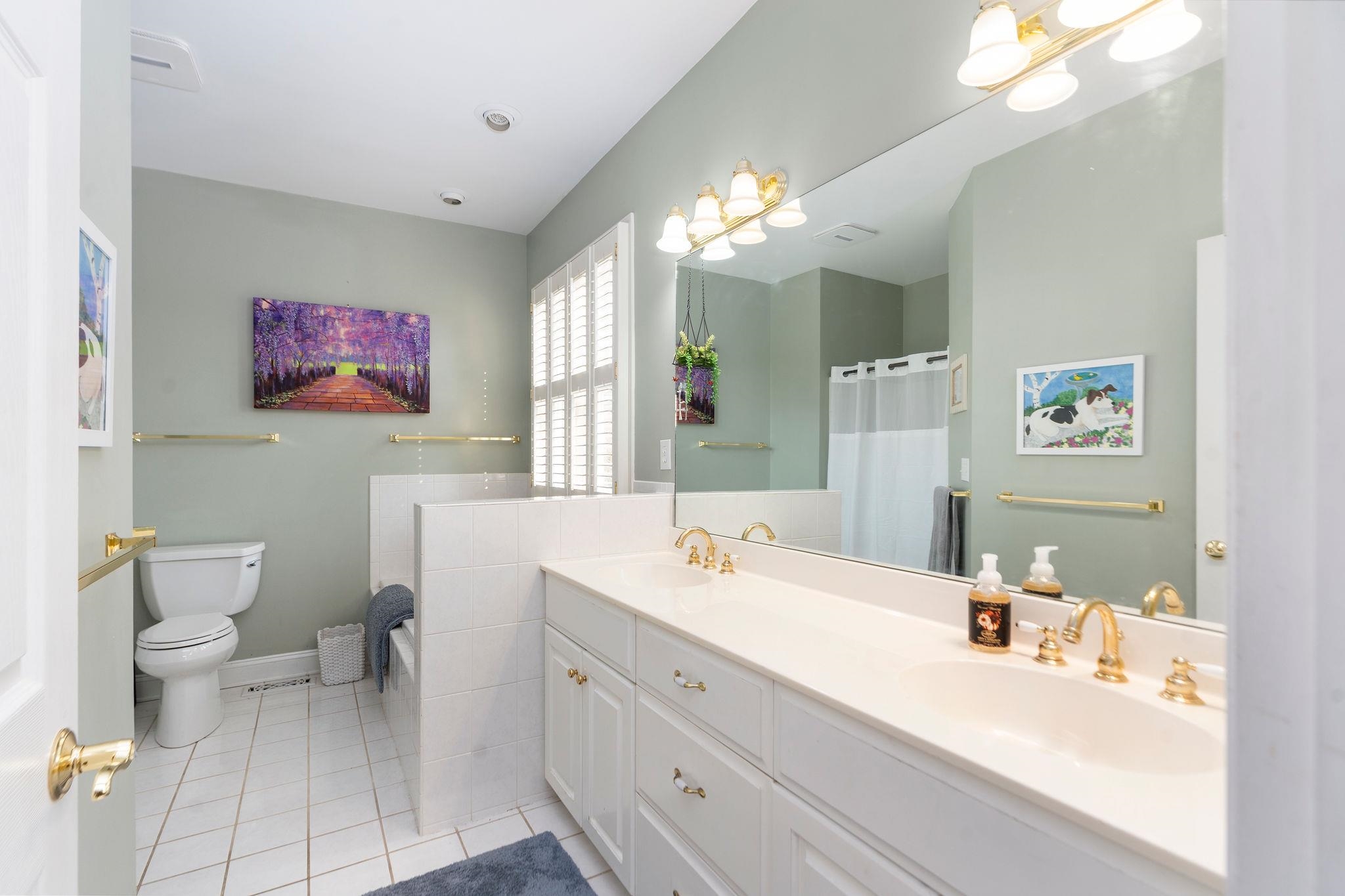 Double sink vanity, soaking tub, and walk in shower.