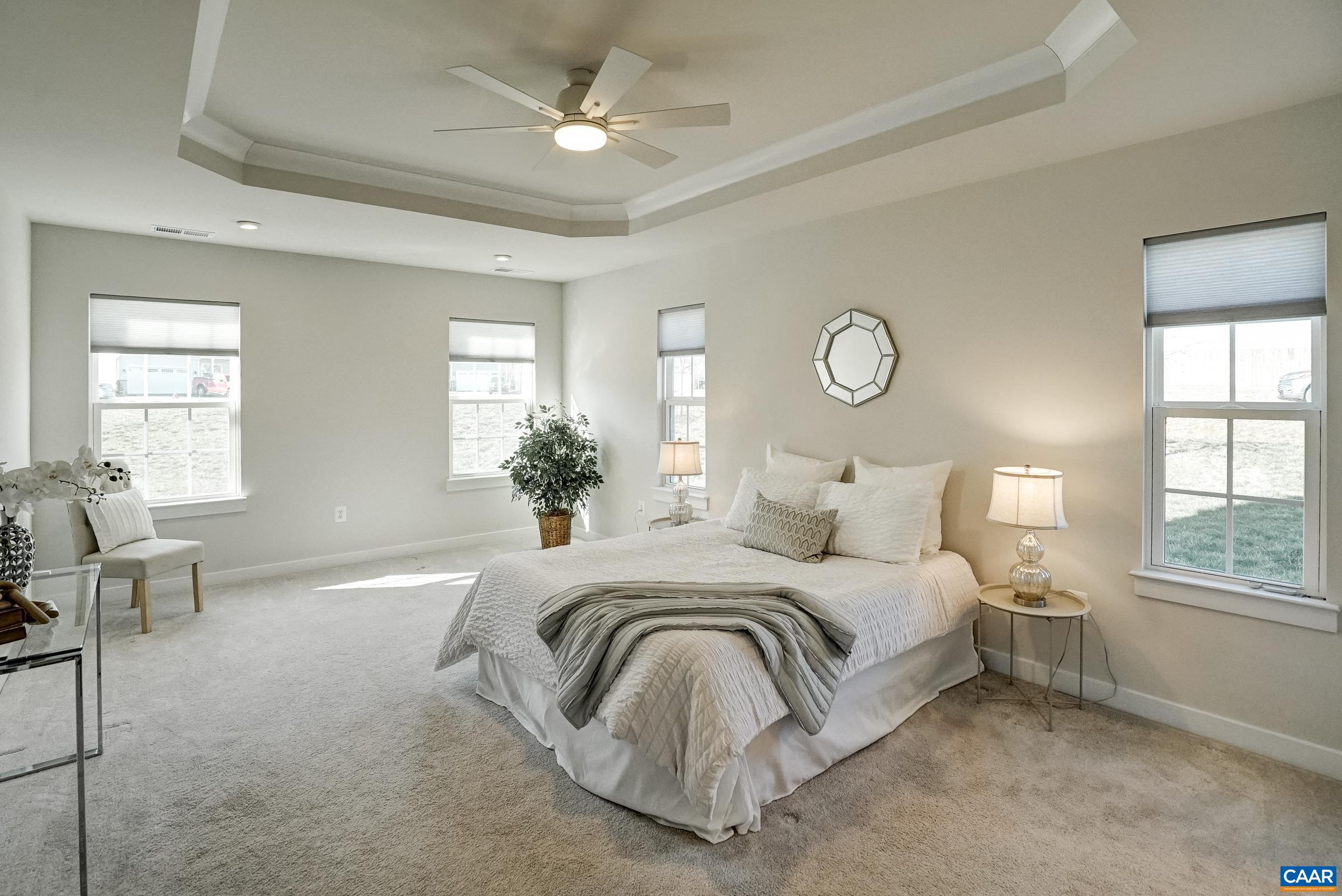 Main level primary suite features tray ceiling with fan. Main level primary suite features tray ceiling with fan.