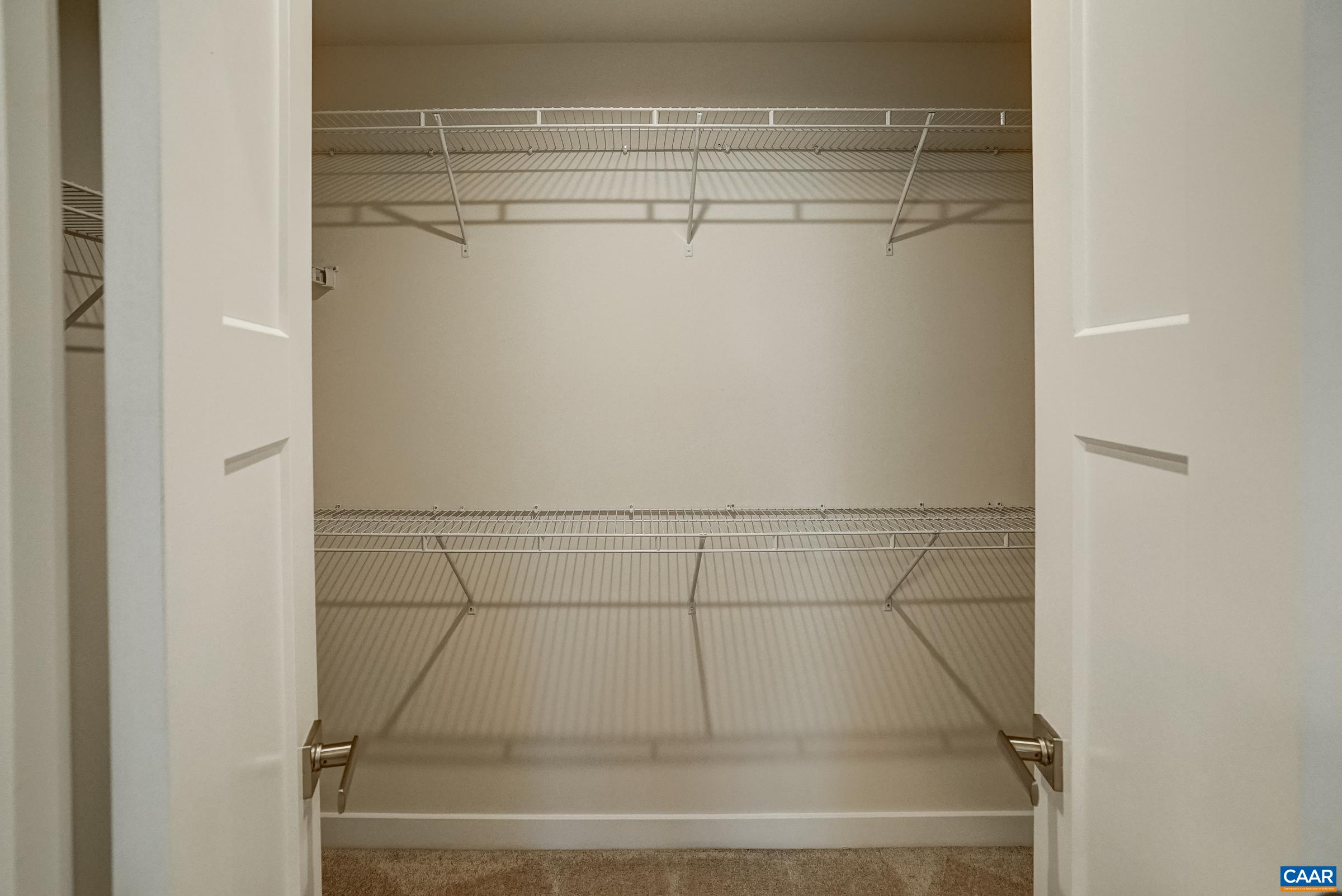 Walk in closet in primary suite. Walk in closet in primary suite.