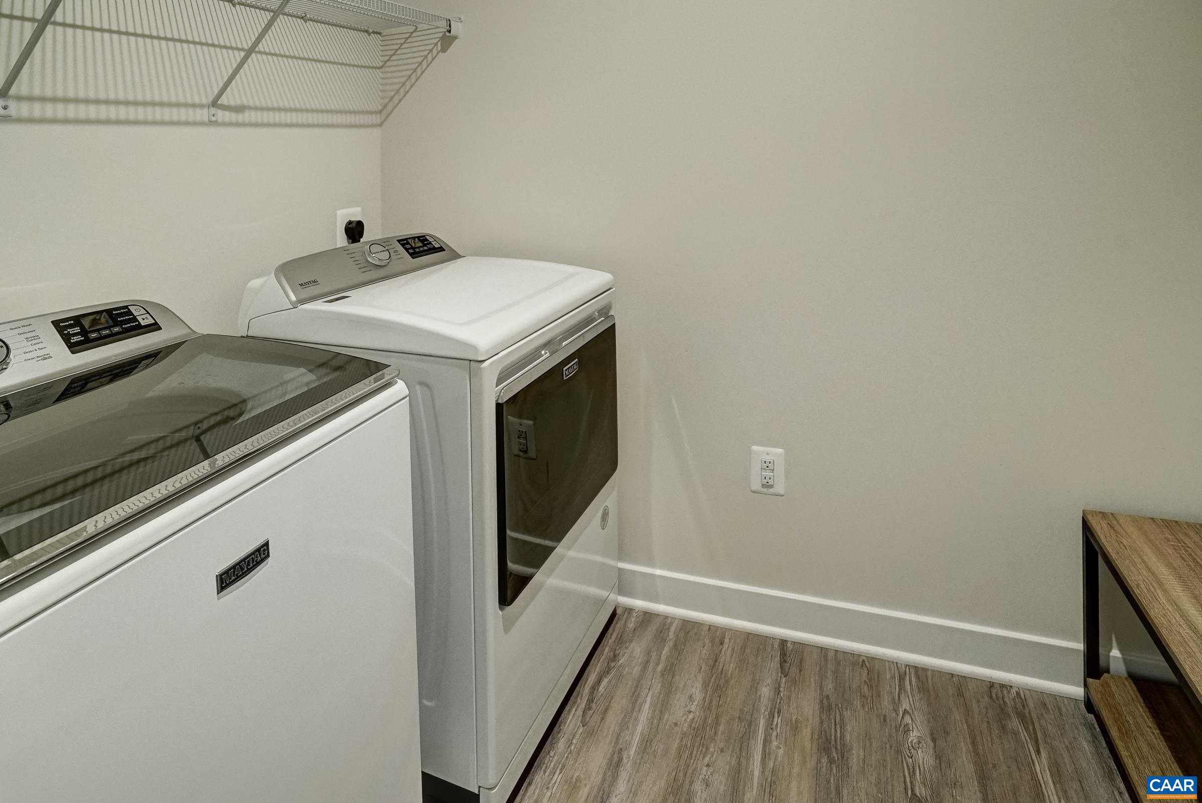 Main floor laundry room features Maytag washer and dryer. Main floor laundry room features Maytag washer and dryer.