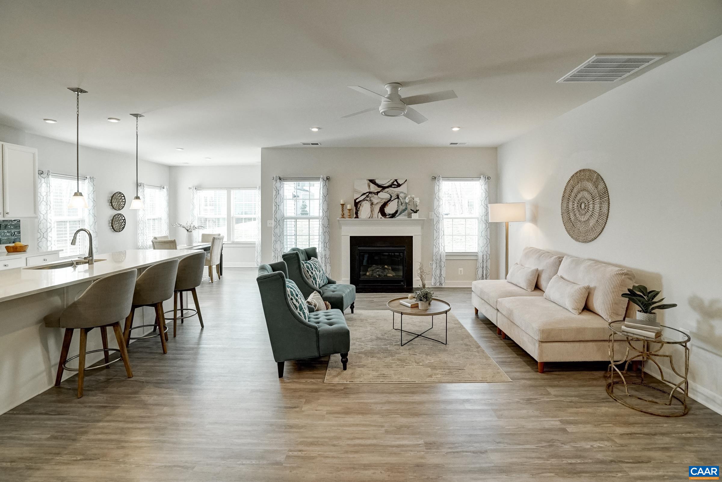 Open great room features a gas fireplace and ceiling fan. Open great room features a gas fireplace and ceiling fan.