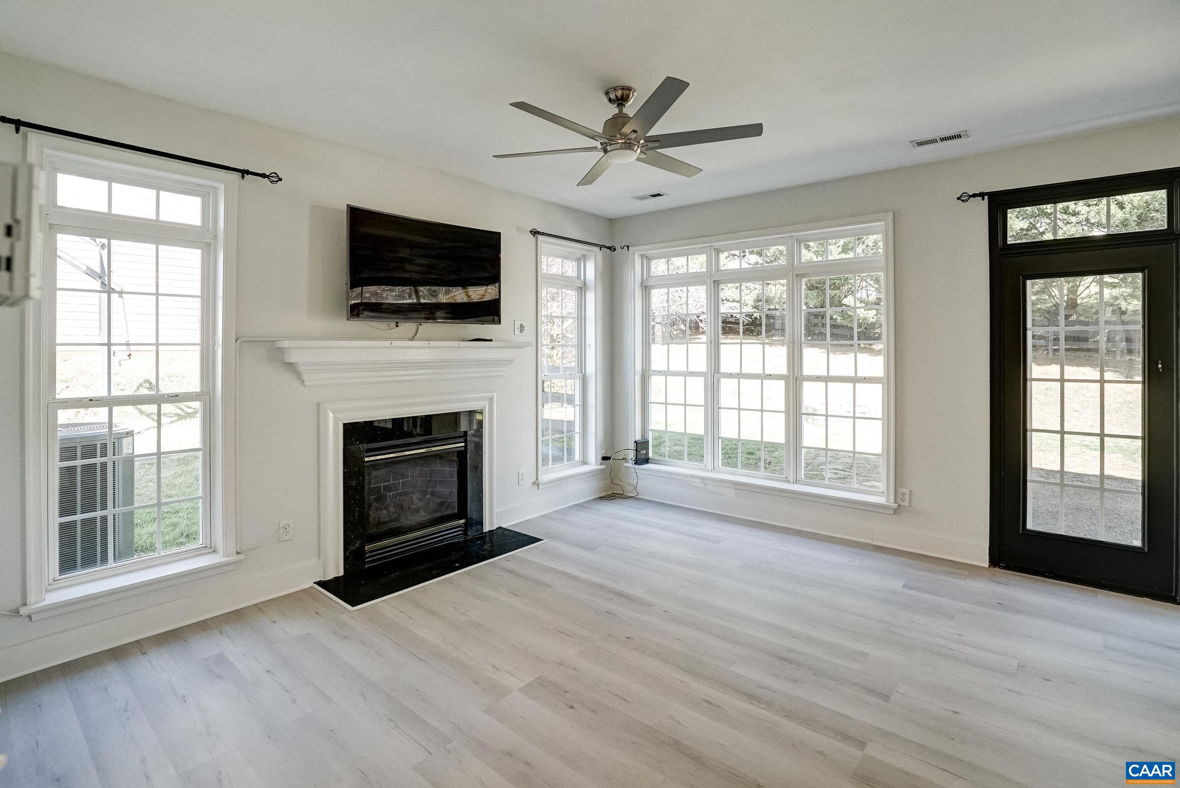 Sunny great room with gas fireplace and remote controlled fan. Sunny great room with gas fireplace and remote controlled fan.
