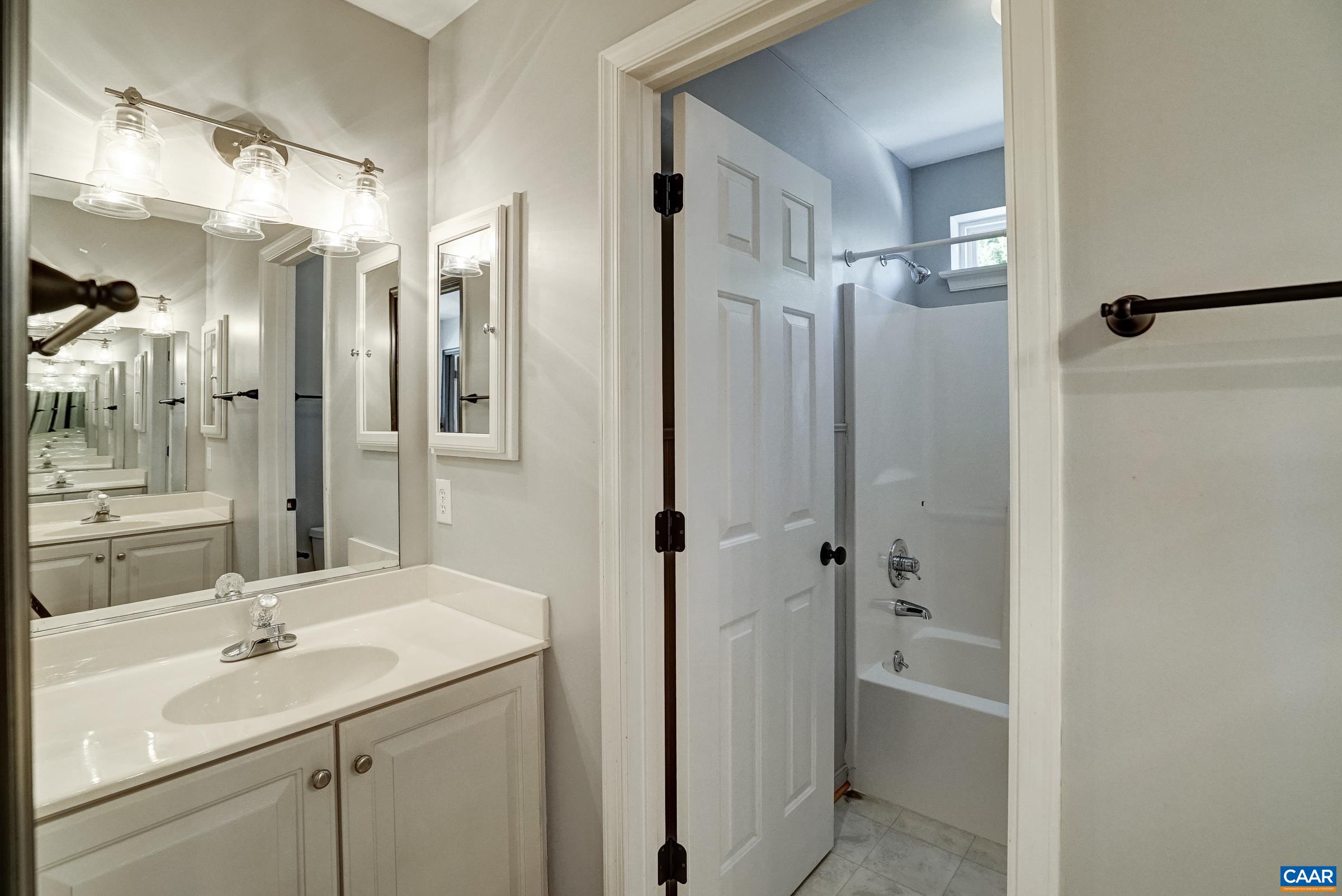 Hall bath with two separate vanities and water closet. Hall bath with two separate vanities and water closet.