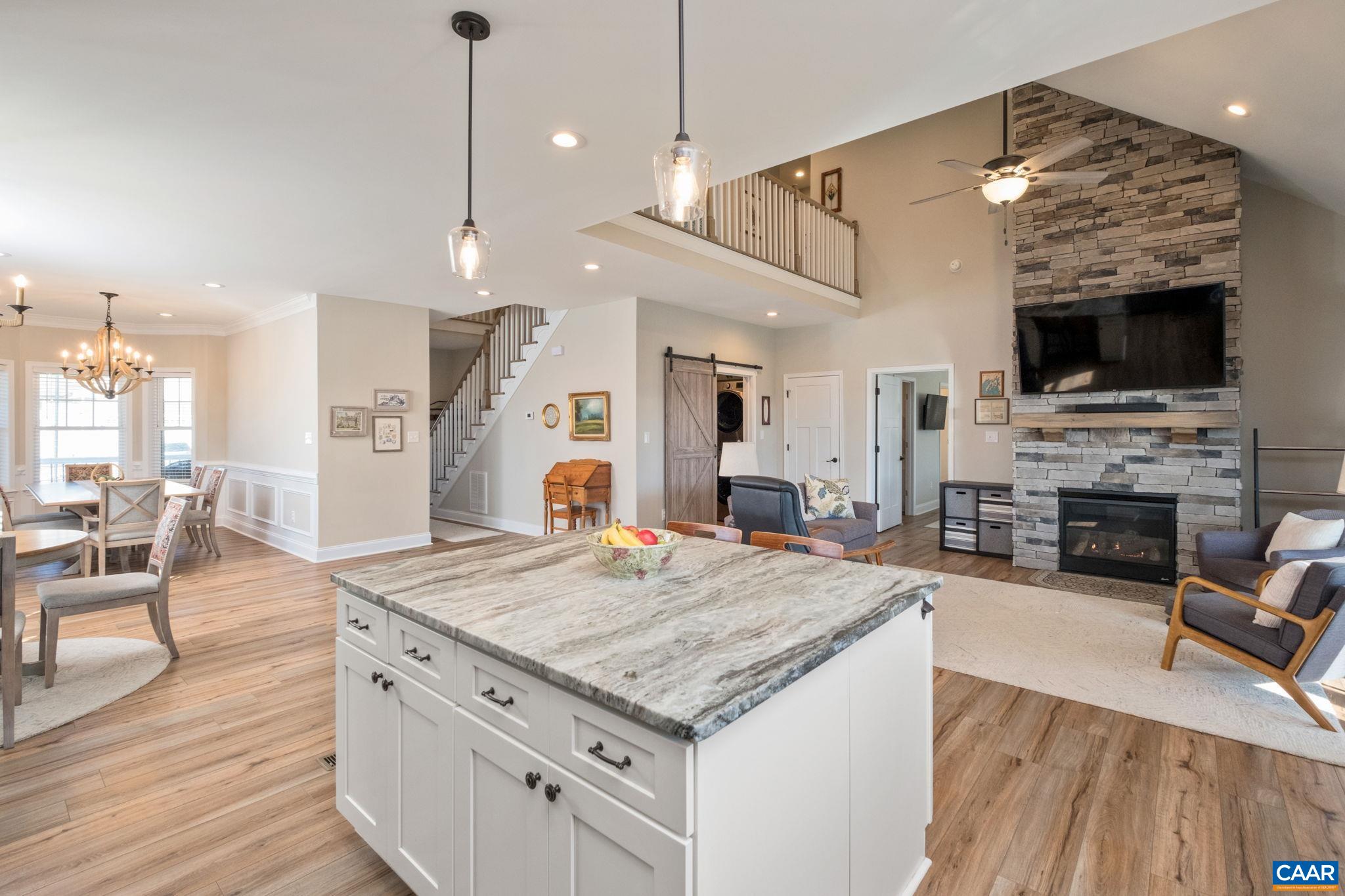 The kitchen is open to the great room, and the great room features a floor-to ceiling fieldstone surround, gas-log fireplace. The kitchen is open to the great room, and the great room features a floor-to ceiling fieldstone surround, gas-log fireplace.