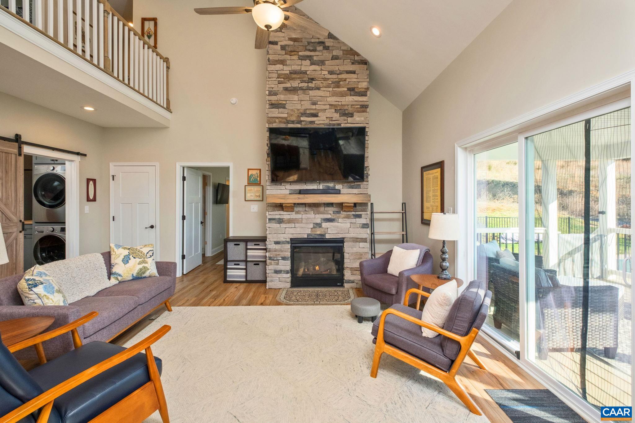 The great room features a vaulted ceiling, and a floor-to-ceiling fieldstone fireplace surround. The great room features a vaulted ceiling, and a floor-to-ceiling fieldstone fireplace surround.