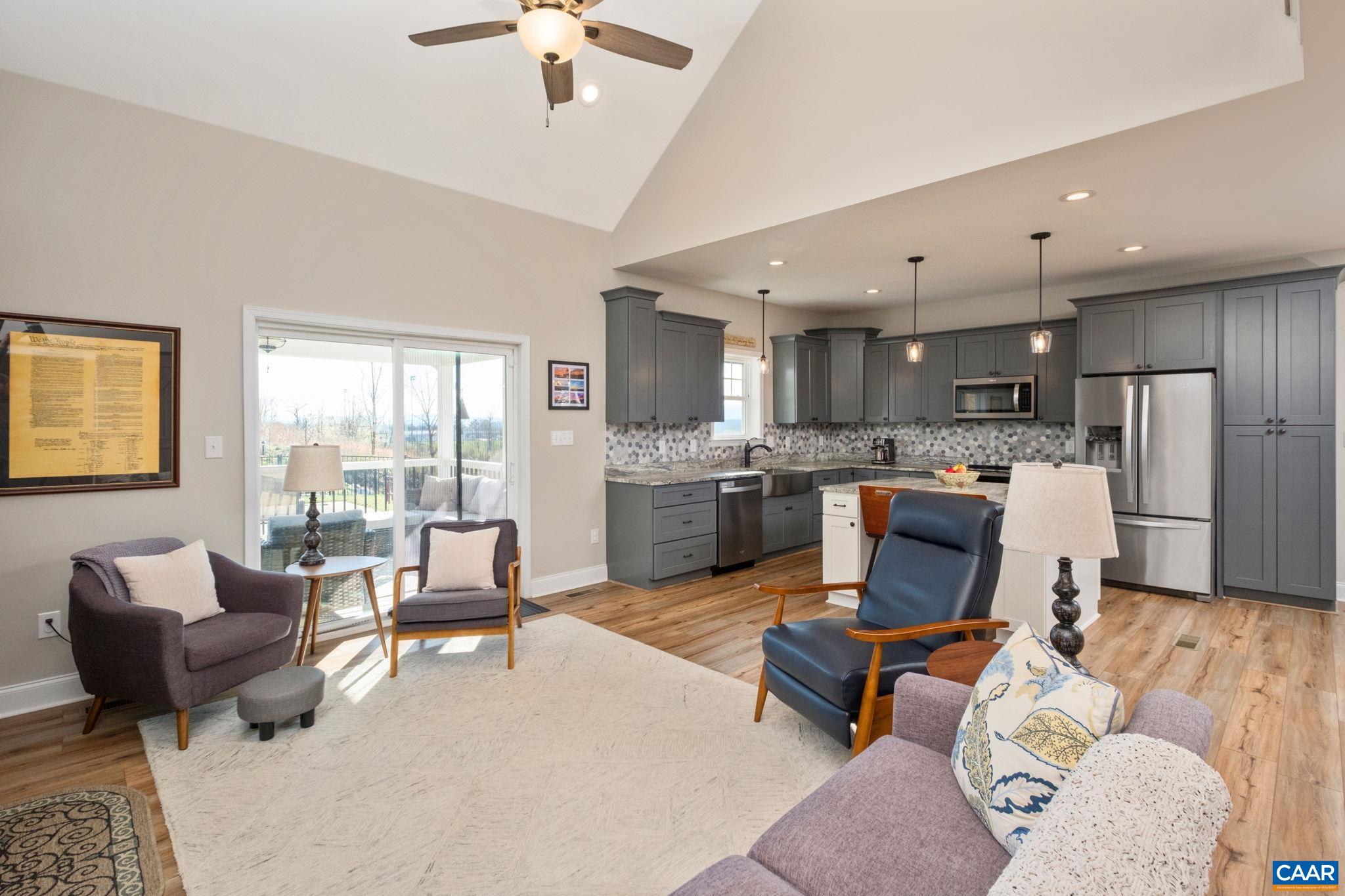 View is from the great room looking to the back covered porch and the kitchen. View is from the great room looking to the back covered porch and the kitchen.