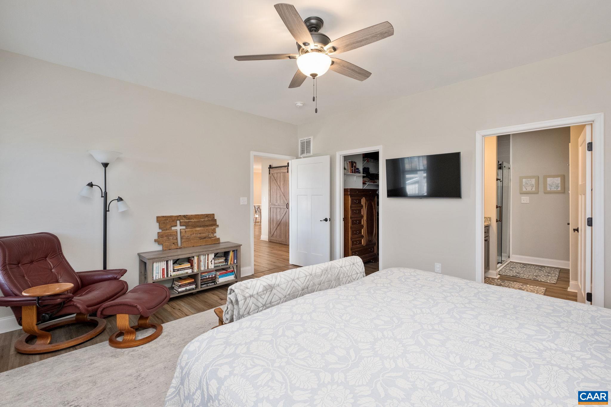 The walk-in closet and the primary bathroom are in view. The walk-in closet and the primary bathroom are in view.