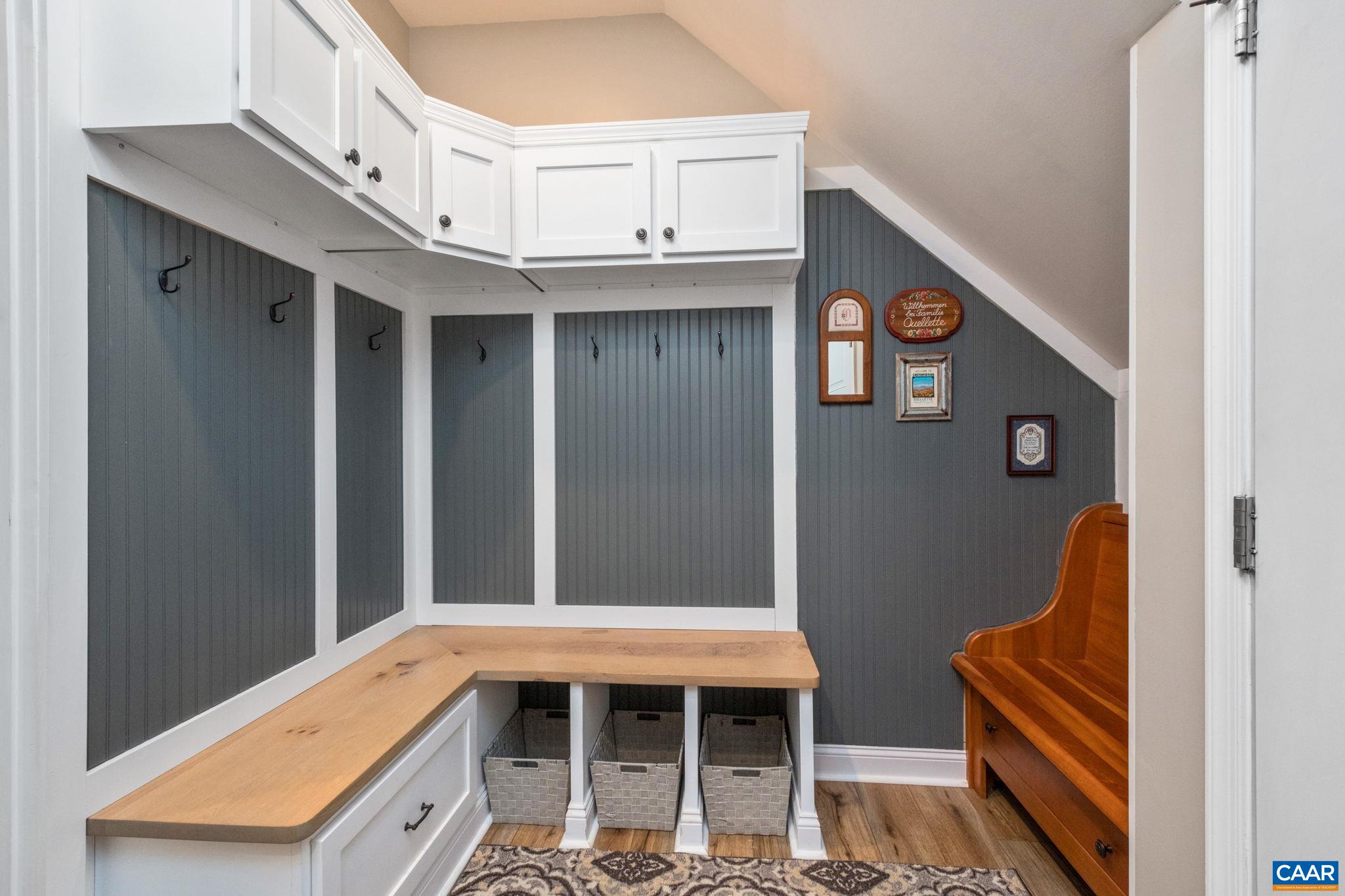 The customized arrival center is located off the garage, and features bench seating, storage, custom-built cabinetry, and the washer and dryer. The customized arrival center is located off the garage, and features bench seating, storage, custom-built cabinetry, and the washer and dryer.