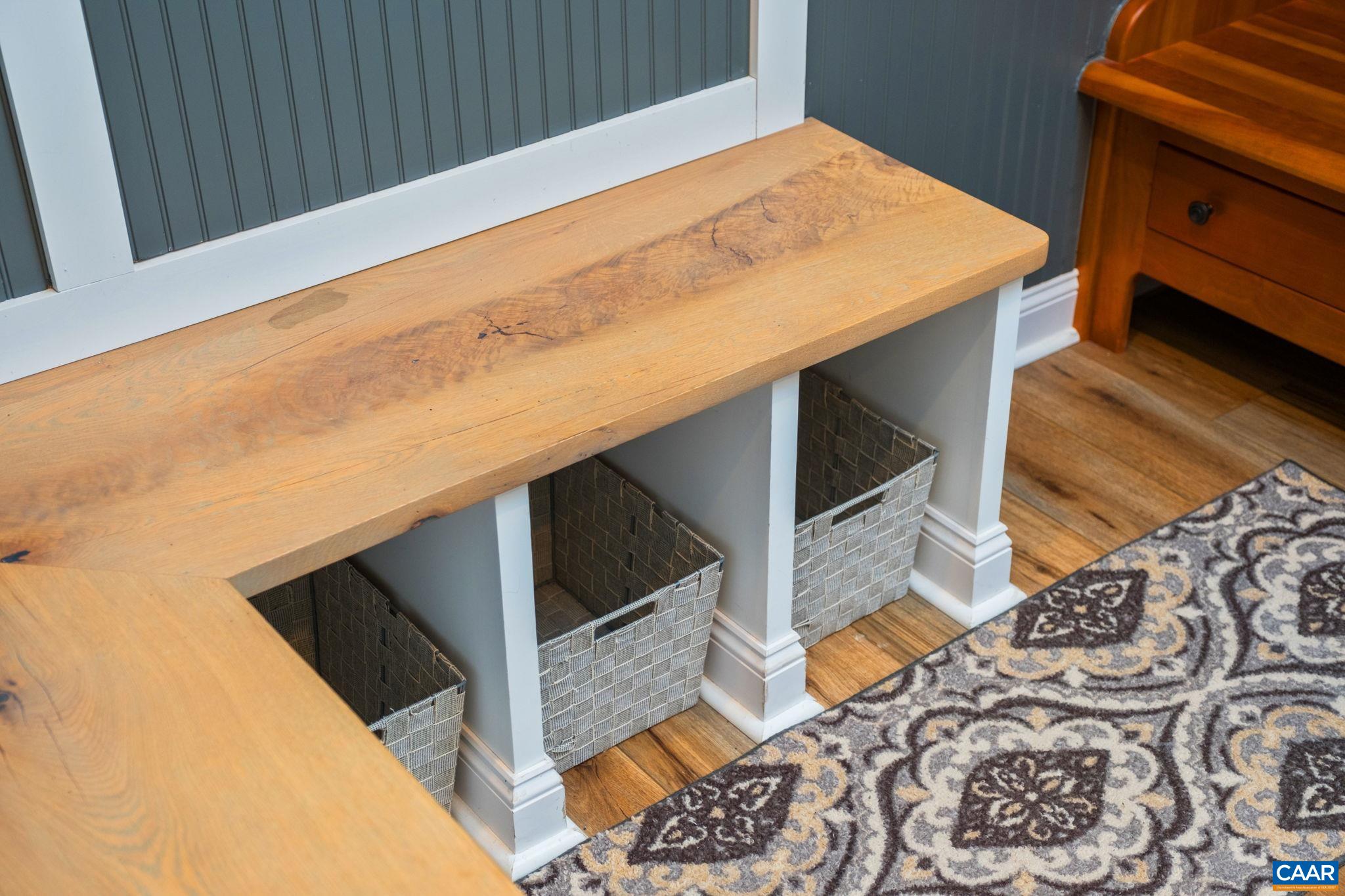 The arrival center includes a seating area with storage underneath. The arrival center includes a seating area with storage underneath.