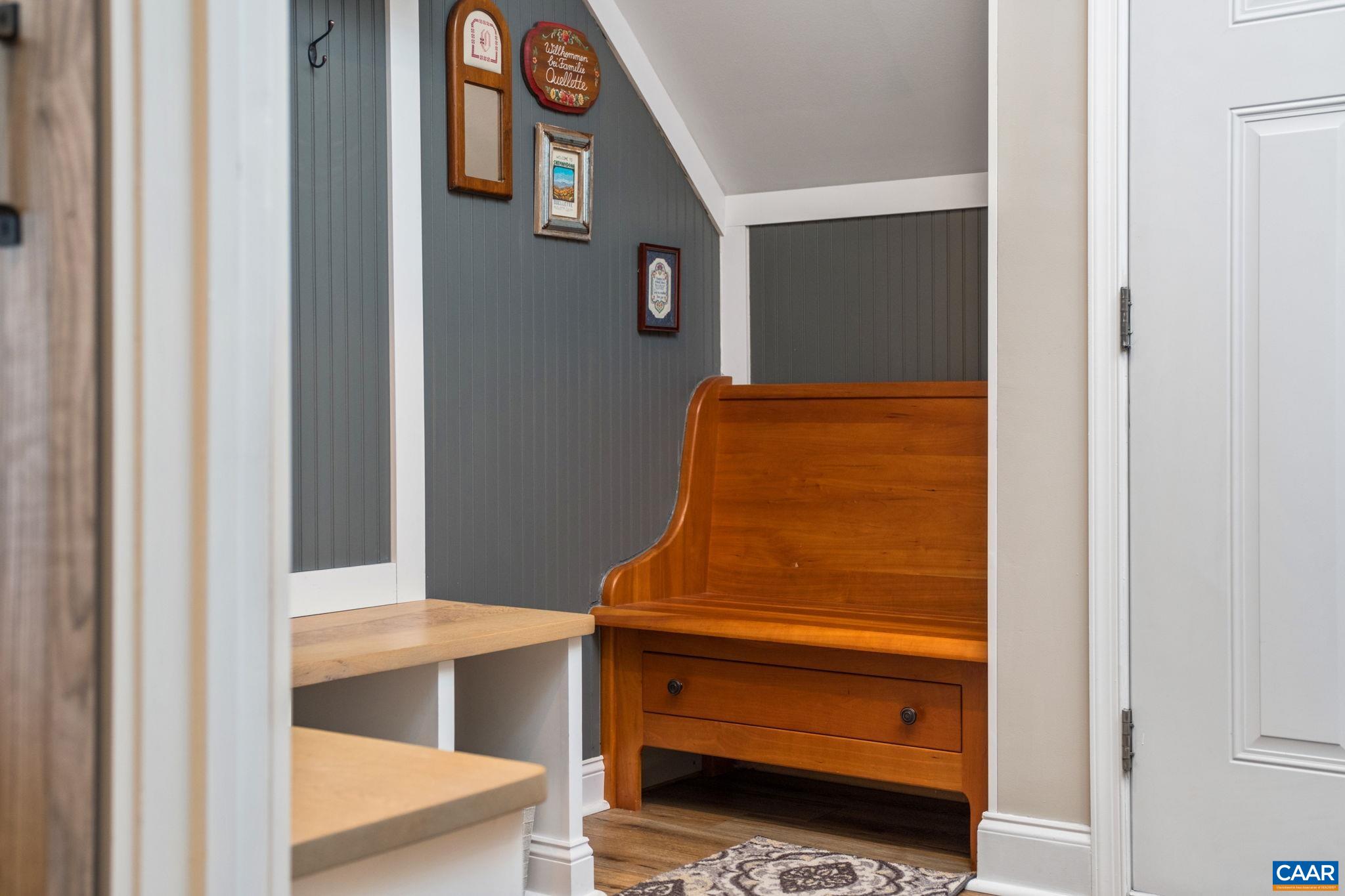 The antique bench, an heirloom, is now a built-in custom feature of the arrival center. The antique bench, an heirloom, is now a built-in custom feature of the arrival center.