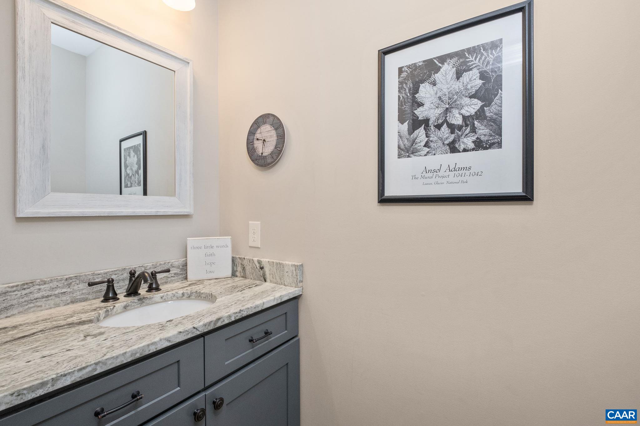 The half bath is located in the entry hallway and features leathered granite countertop. The half bath is located in the entry hallway and features leathered granite countertop.