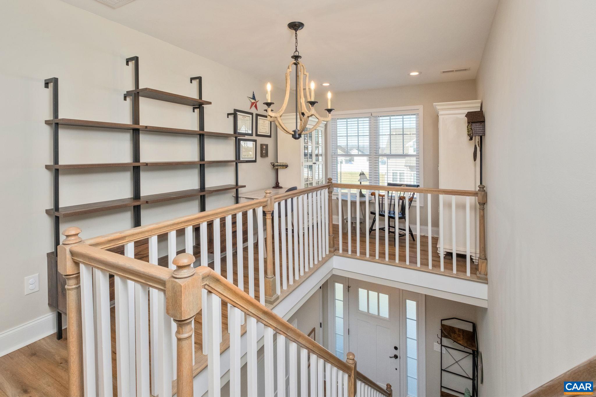 The space at the top of the stairs has built-in bookshelves and can be used for a home office, library, or sitting area. The space at the top of the stairs has built-in bookshelves and can be used for a home office, library, or sitting area.