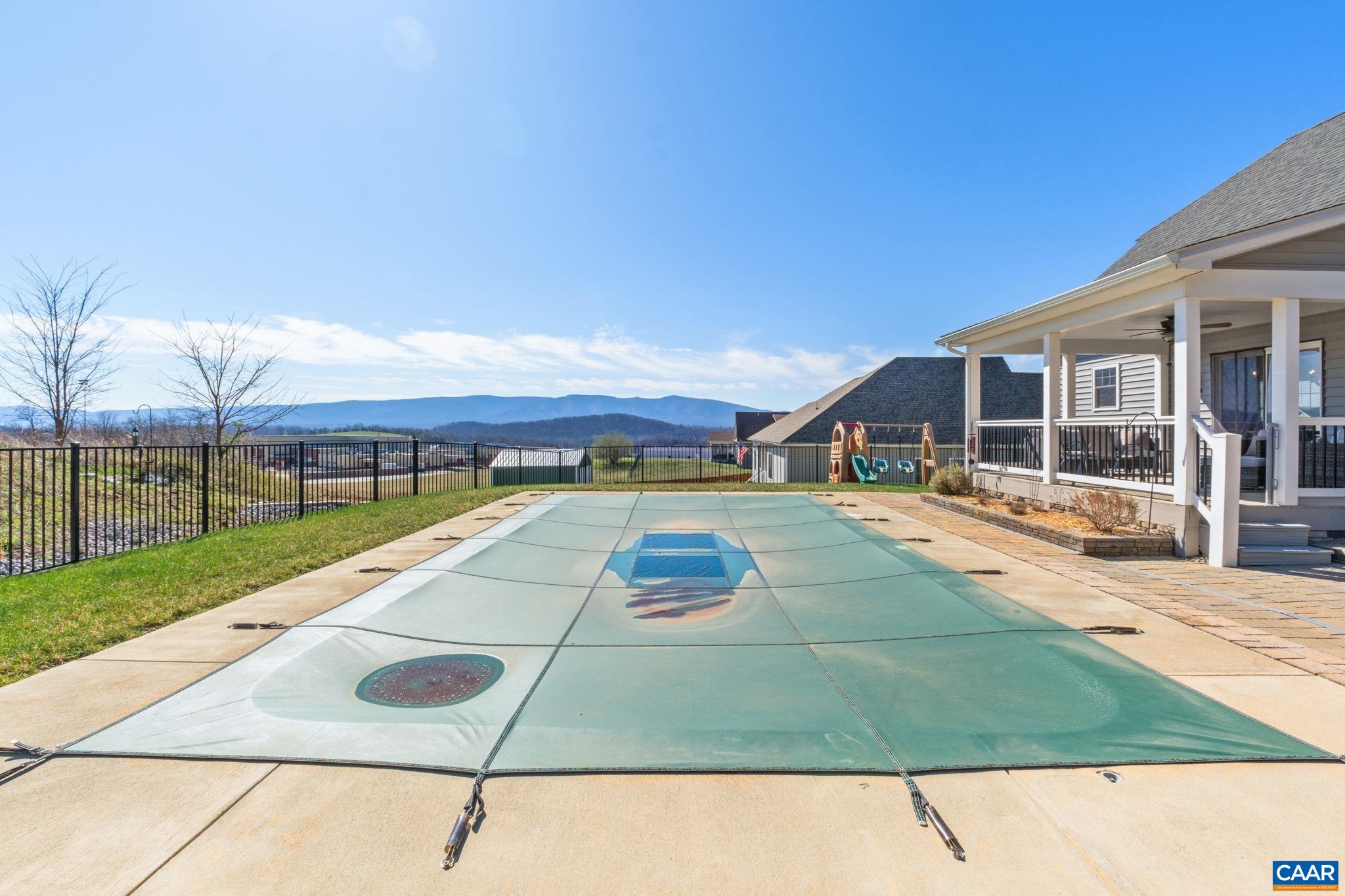 The heated saltwater pool features a safety cover for peace of mind. A retaining wall was added to level off the backyard, and French drains and swells were added for peace of mind. The heated saltwater pool features a safety cover for peace of mind. A retaining wall was added to level off the backyard, and French drains and swells were added for peace of mind.