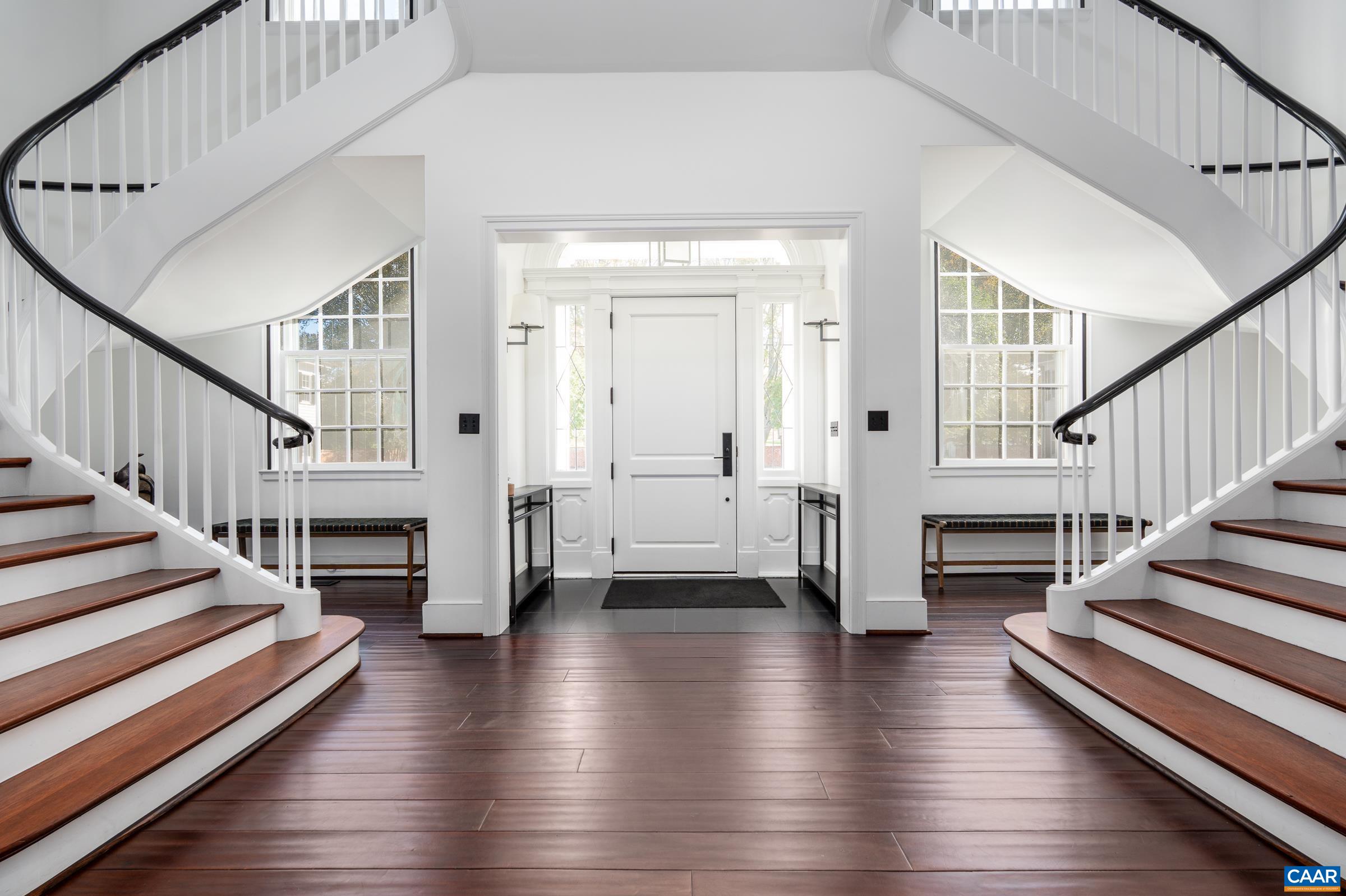 With sweeping staircases and hickory floors throughout.