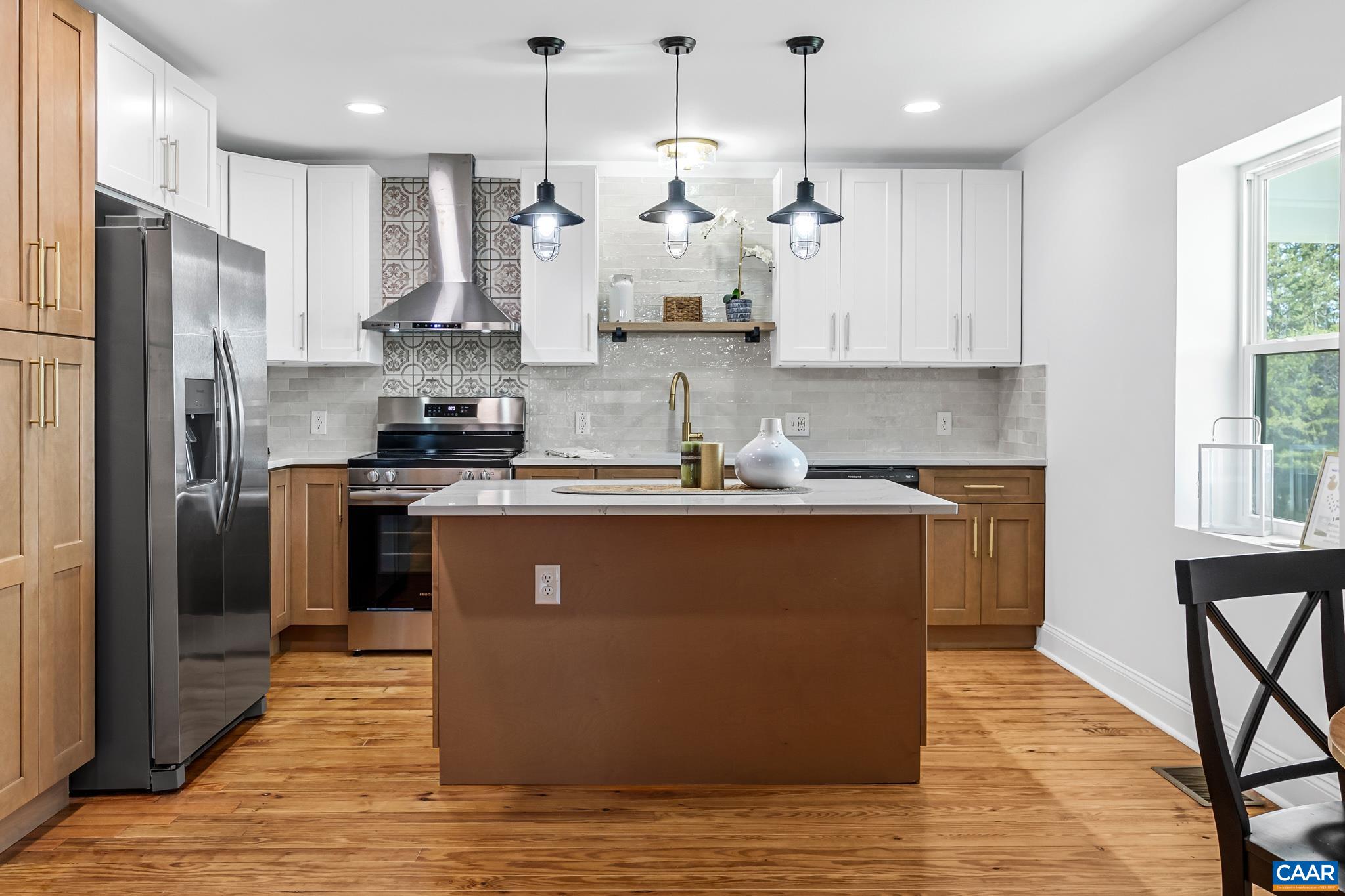 Gorgeous upgraded kitchen featuring dovetail soft-close drawers, quartz countertops, all new appliances, and fresh tile backsplash.