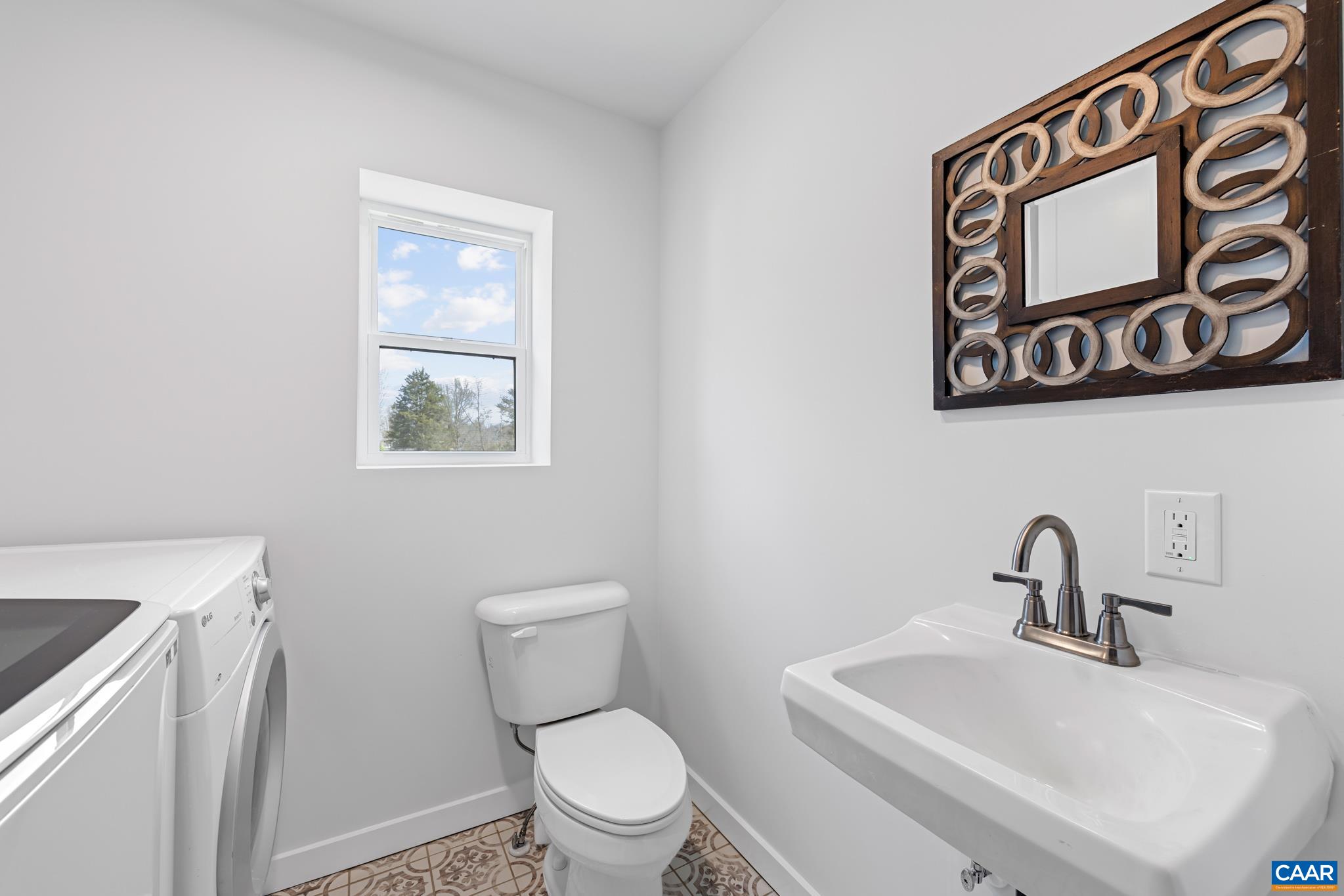 Freshly renovated laundry + powder room—clean, functional, and beautifully updated.