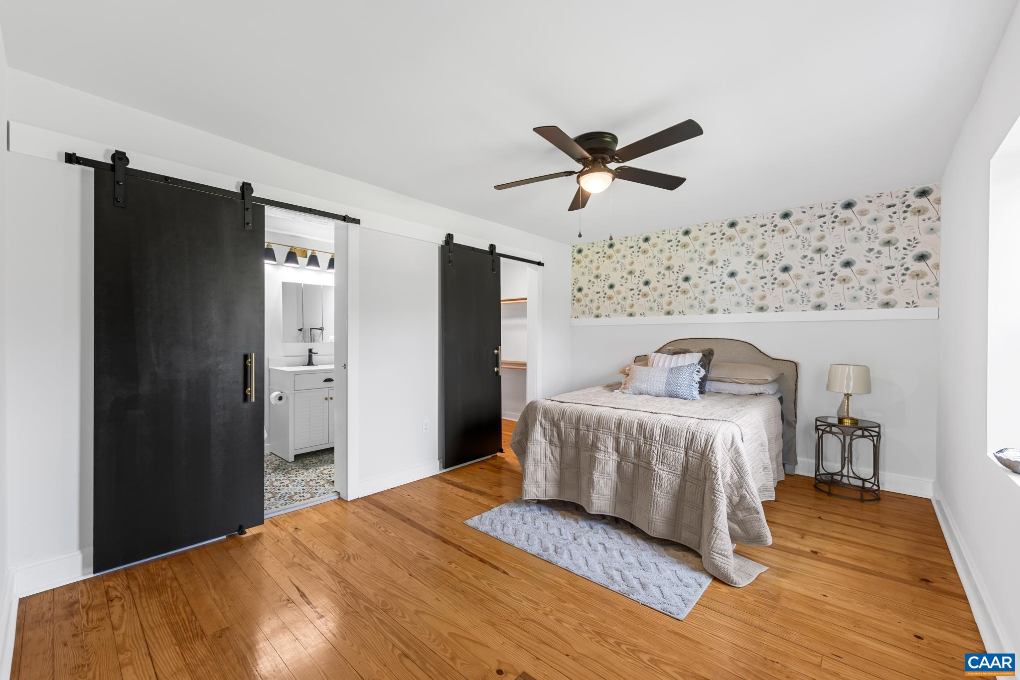 Enjoy a beautiful first-floor primary suite featuring a freshly renovated bathroom and a spacious walk-in closet, with original refinished hardwood flooring.