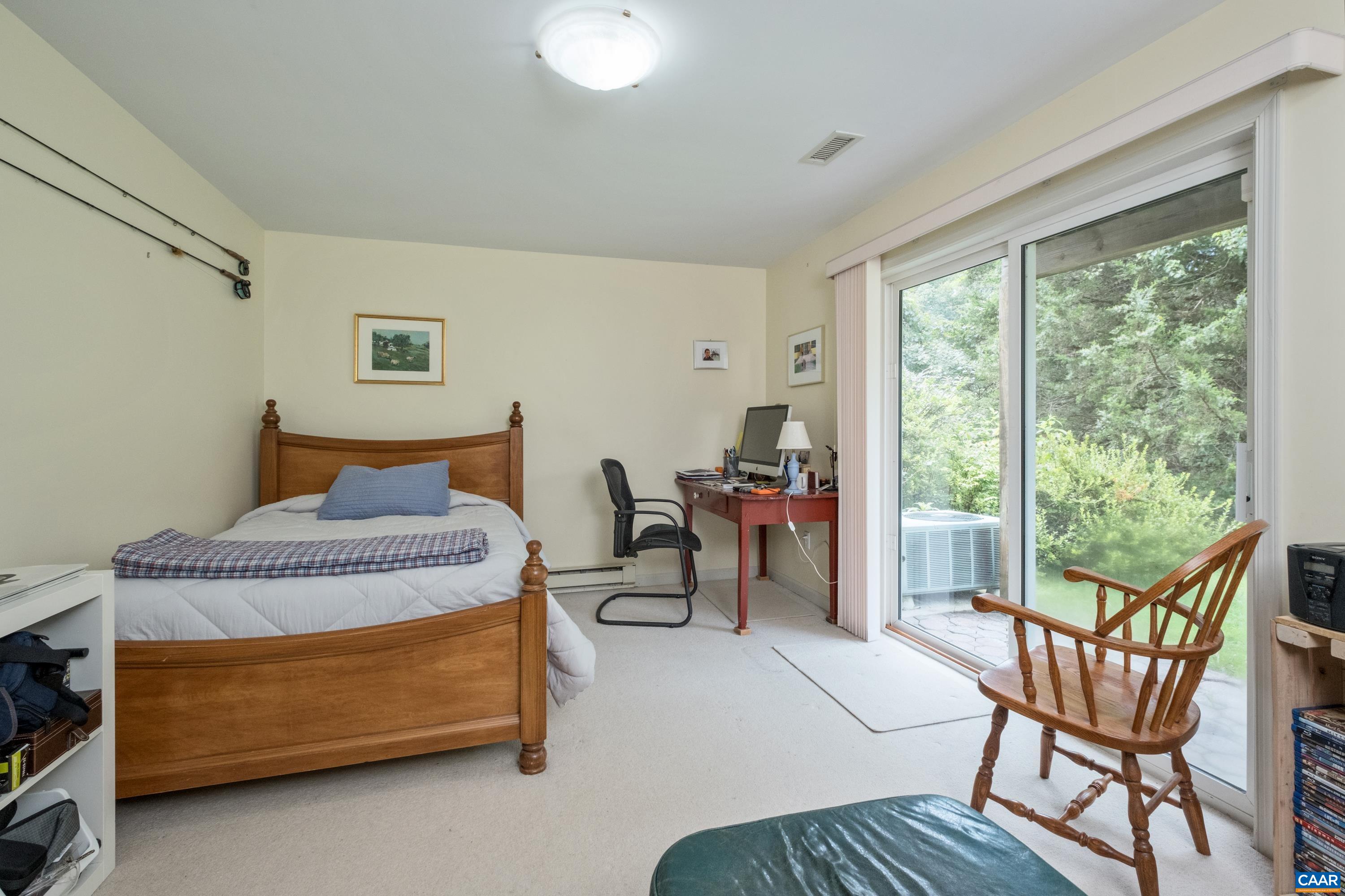 Fifth bedroom teen or in-law suite with private bath, separate entrance and walkout to patio.