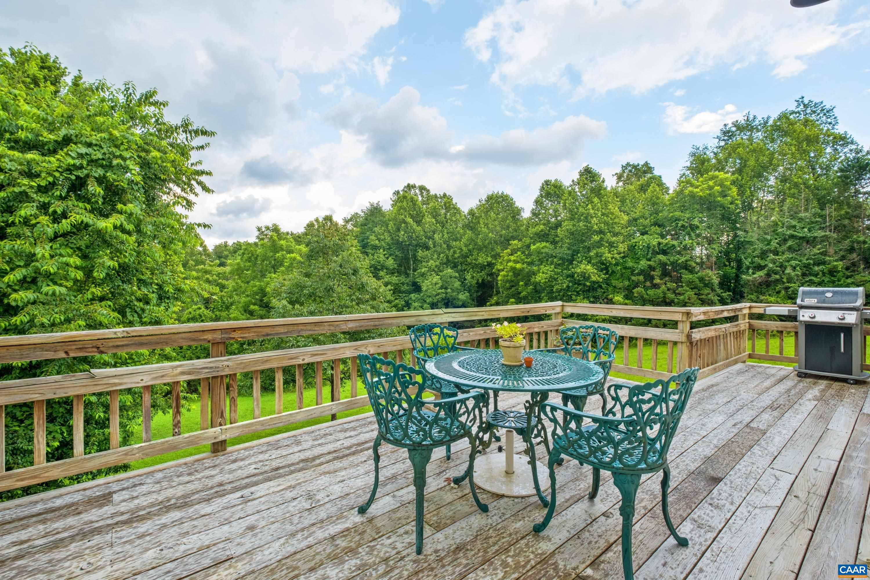 View of open space, wooded back, and pond.
