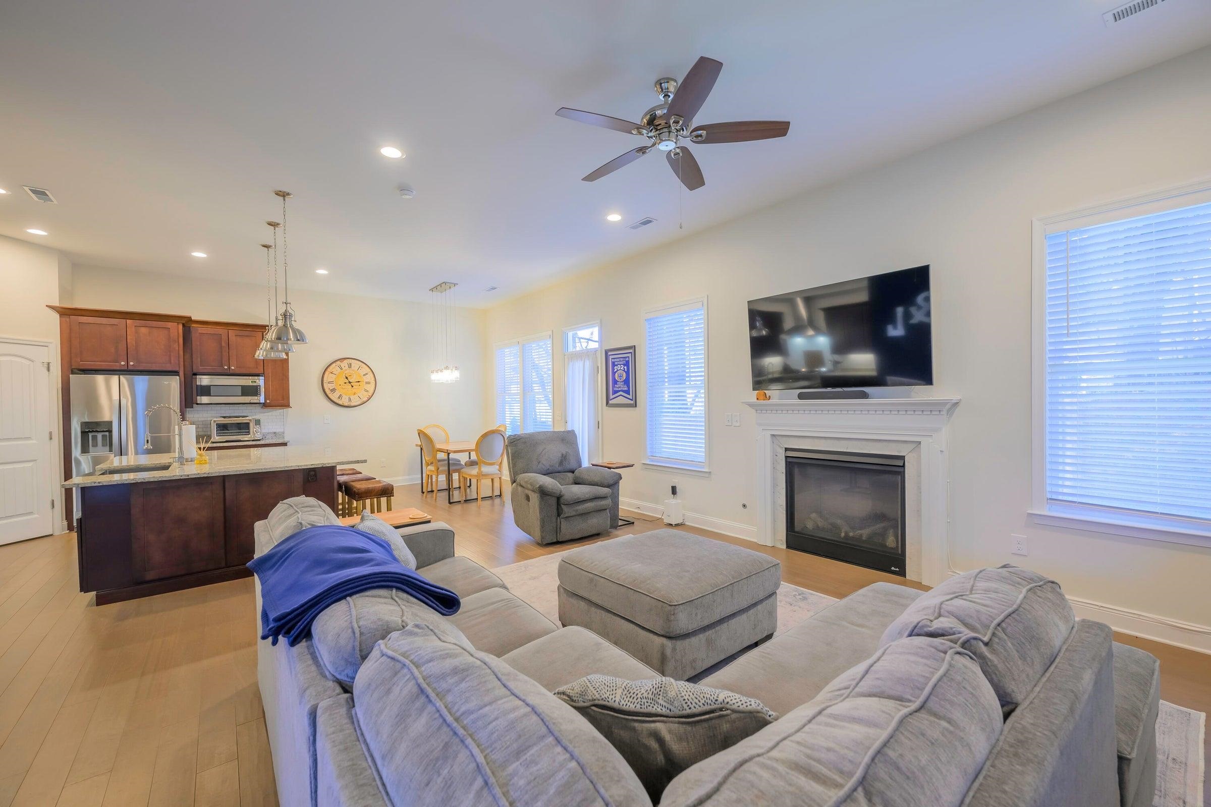 The main living space features a spacious great room with a natural gas fireplace, seamlessly flowing into the dining area and a beautifully appointed gourmet kitchen.
