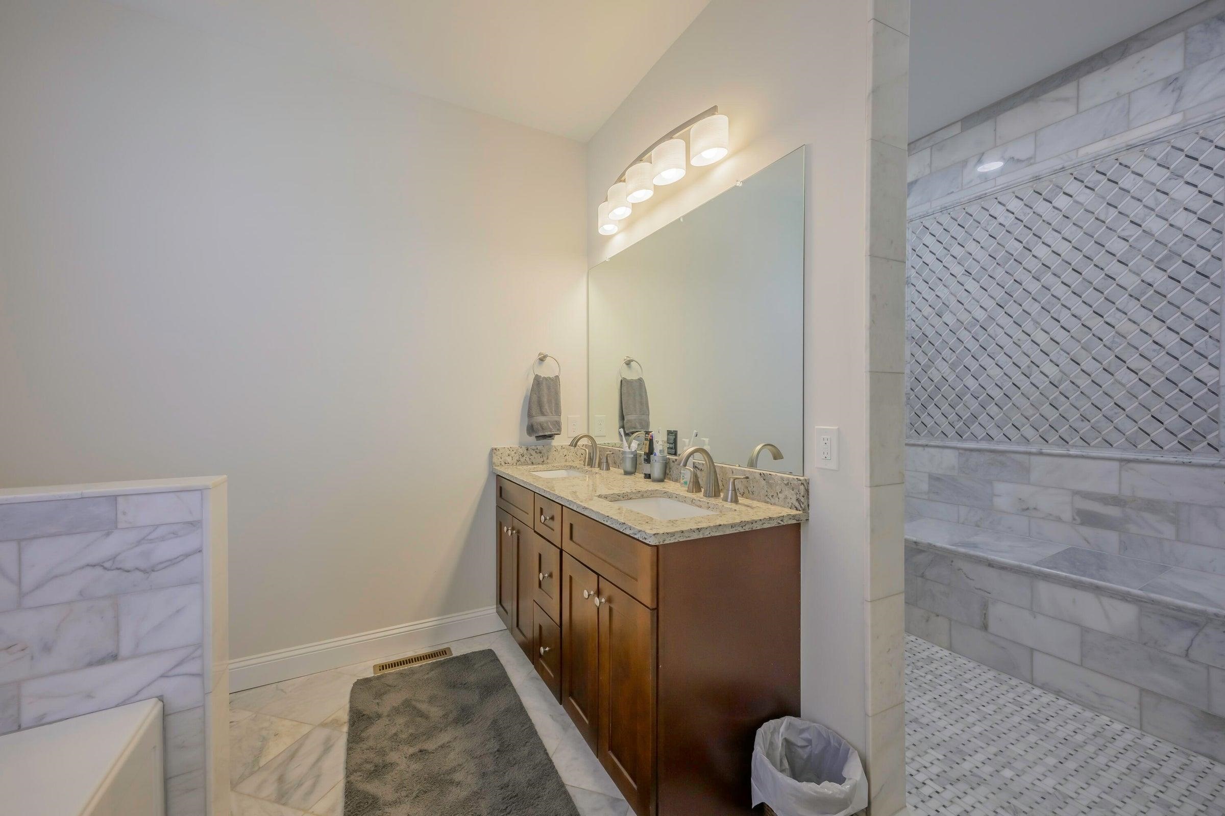 Elegant master bath with a generous walk-in marble shower and soaking tub.