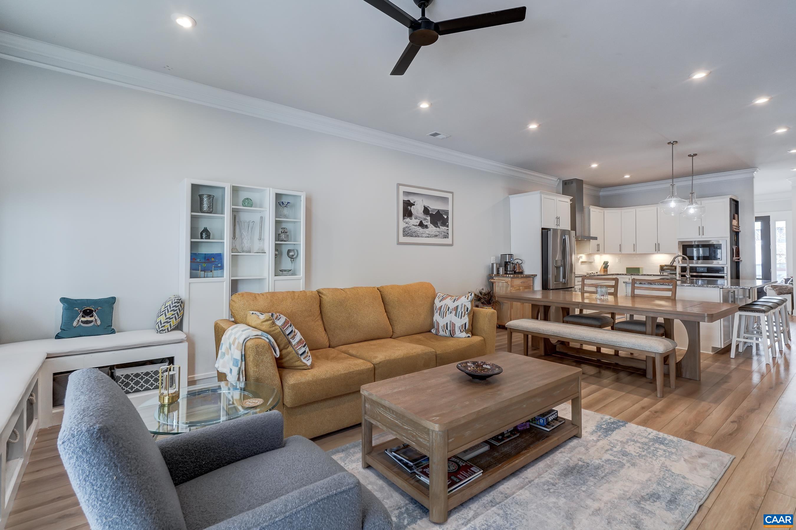 Living room features a modern ceiling fan and built-in bench seating.
