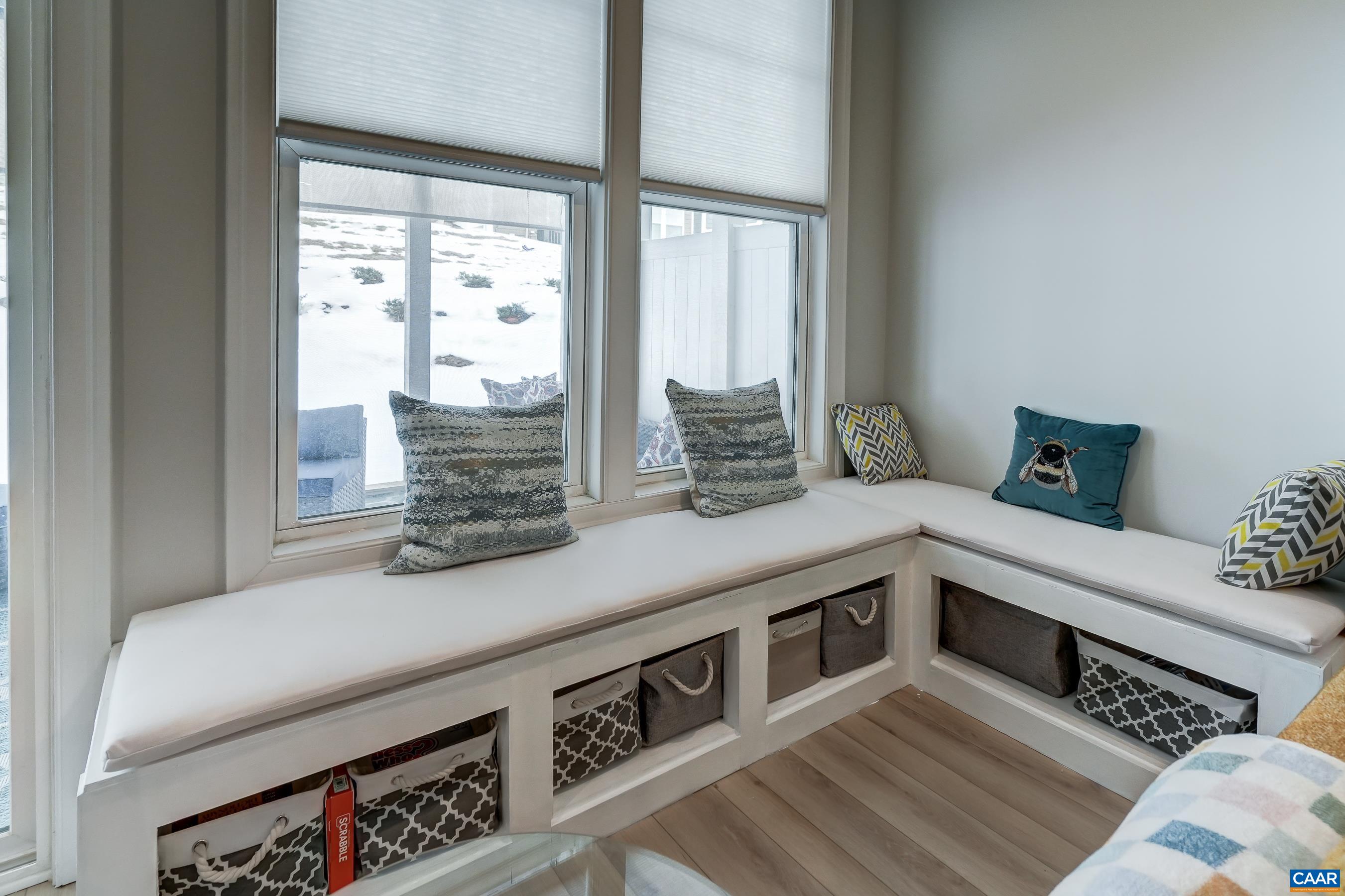 Custom built window seating is the perfect spot for a cozy read, and features built-in storage cubbies.