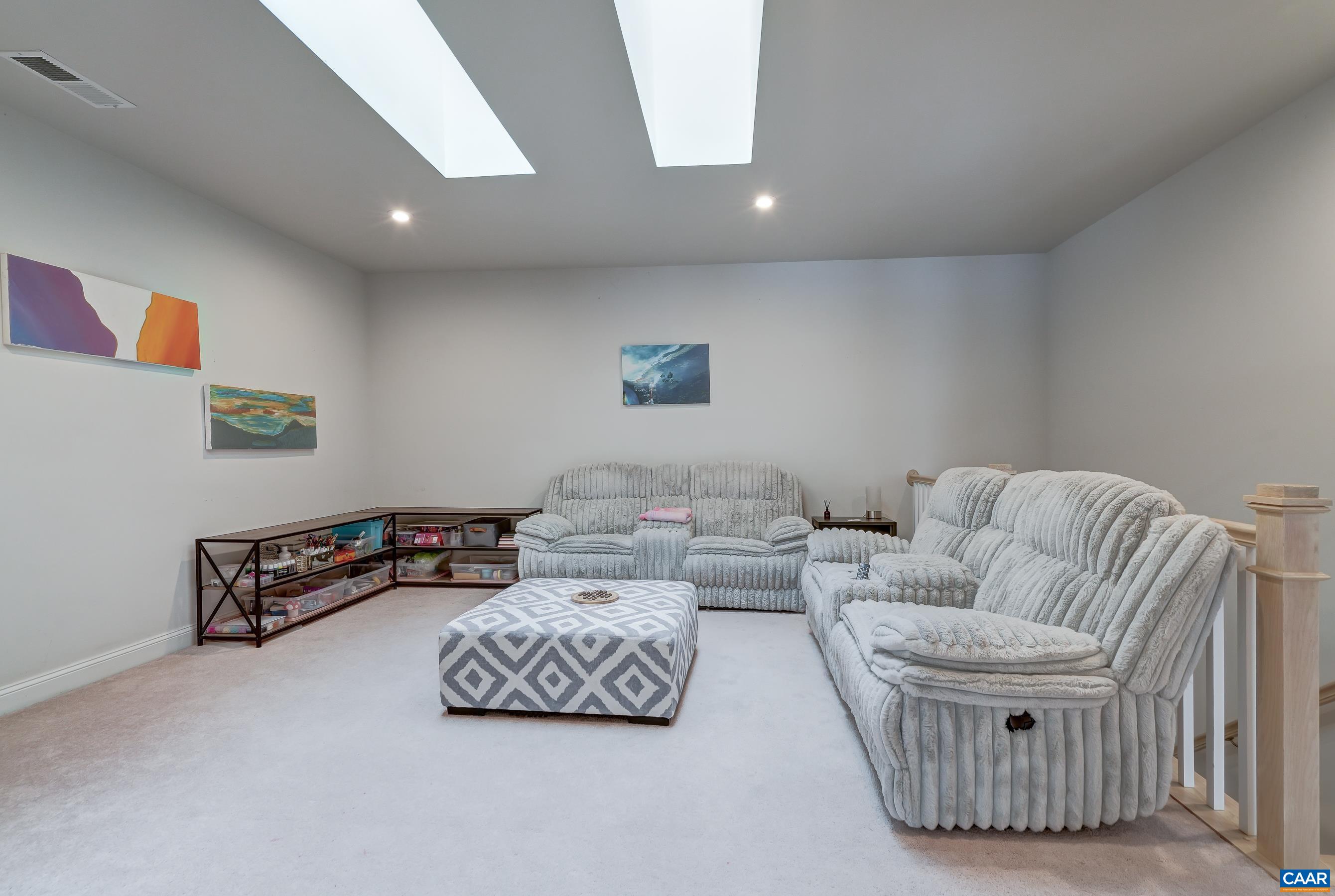Amazing second floor loft space with skylights that create a light and bright playroom, media area or rec room.