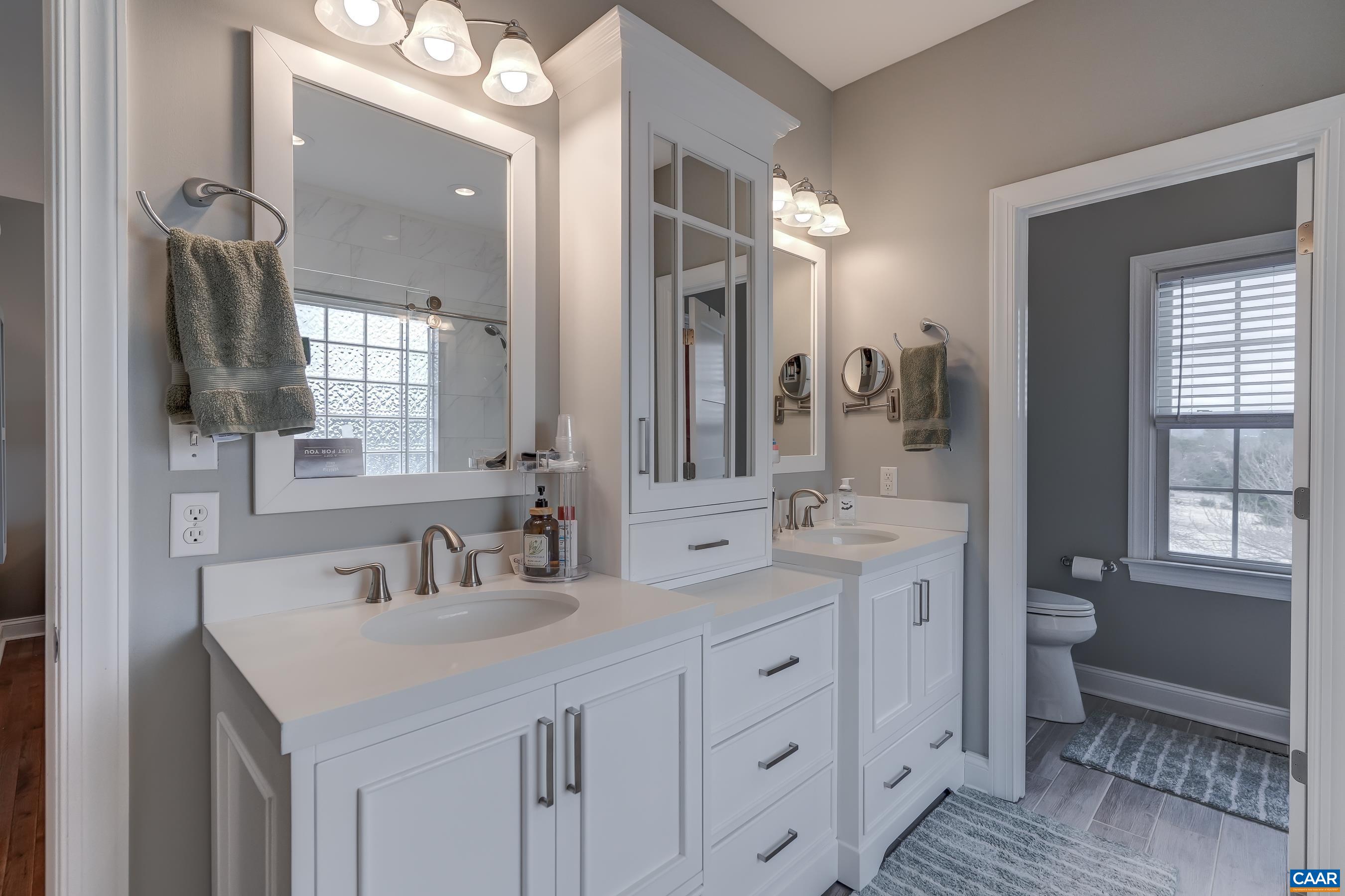 Dual sink vanity with storage tower. Dual sink vanity with storage tower.