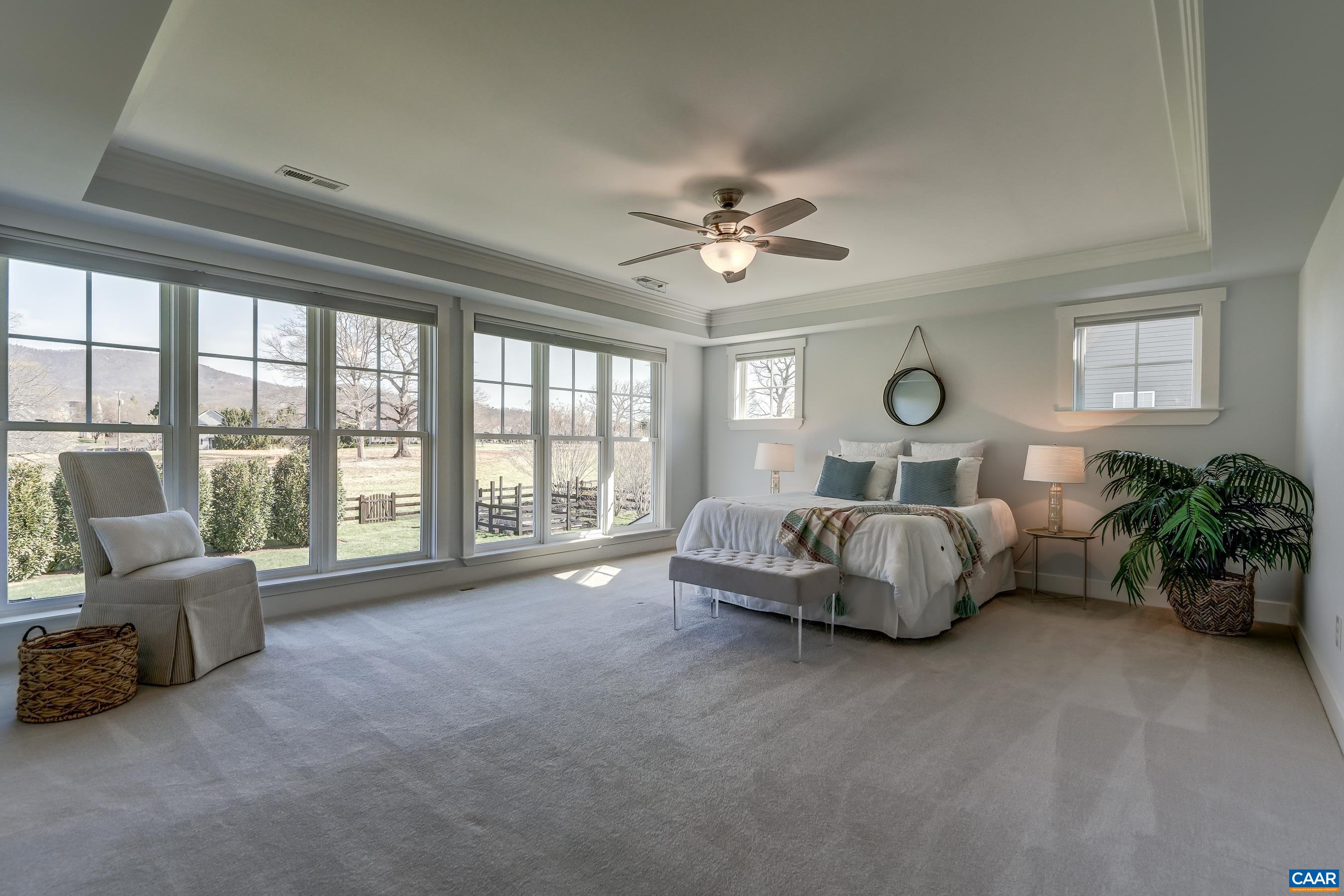 Primary bedroom with two ensuite bathrooms and custom closets!