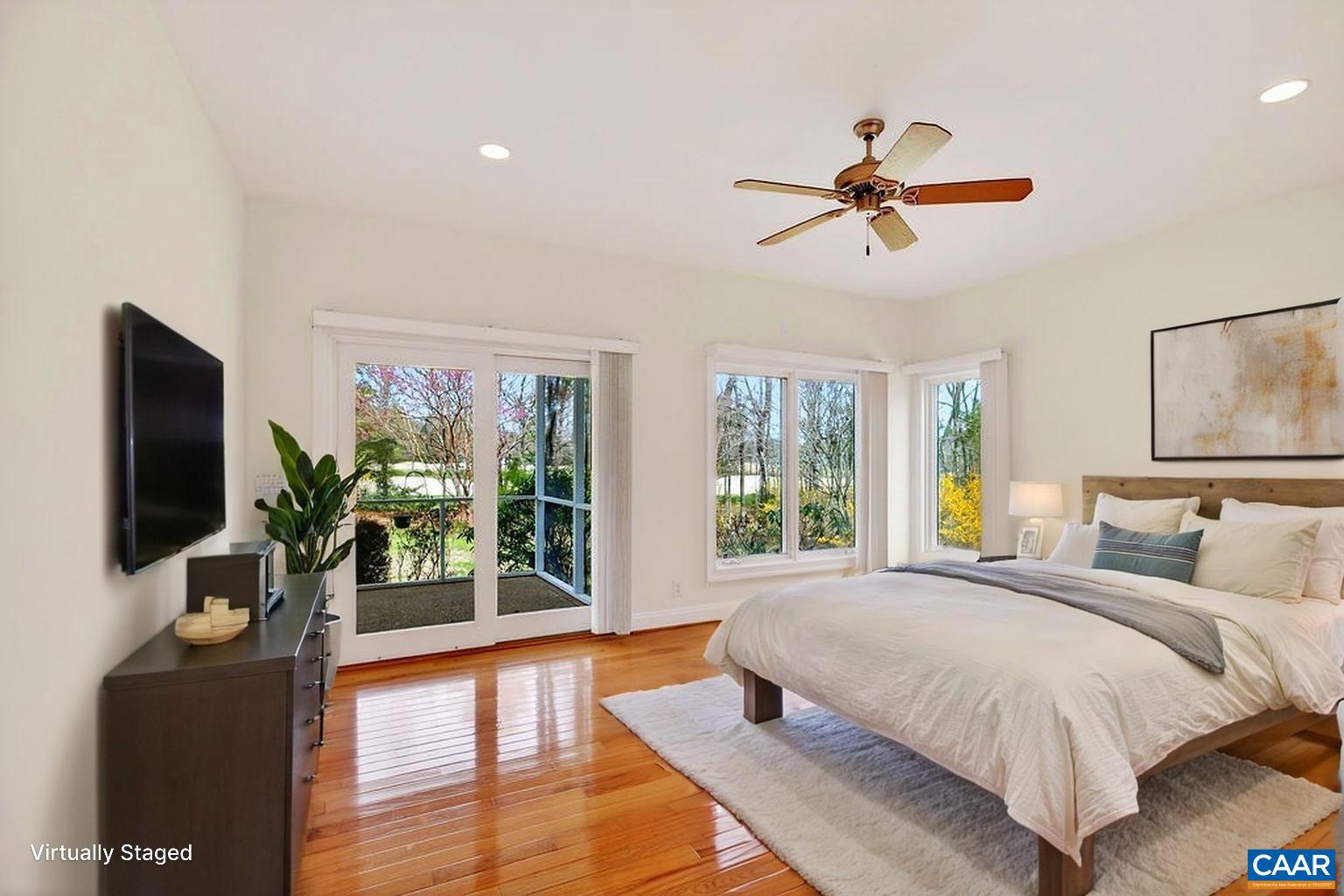 Generously sized primary suite with private access to the screened porch and beautiful mountain views.