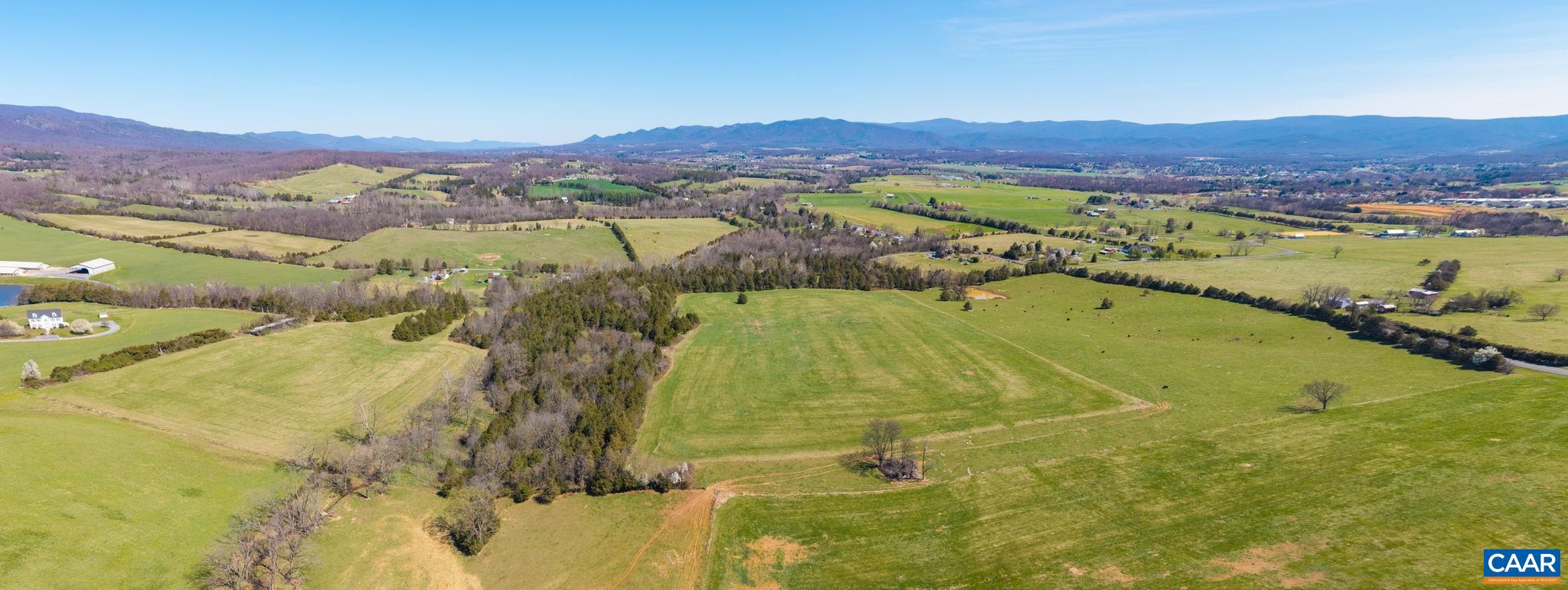 The rear grazing pasture is to the left.  Moving left to right in the picture is the creek and forested ridge, then the front hay pasture, followed by the grazing pasture on the road frontage.