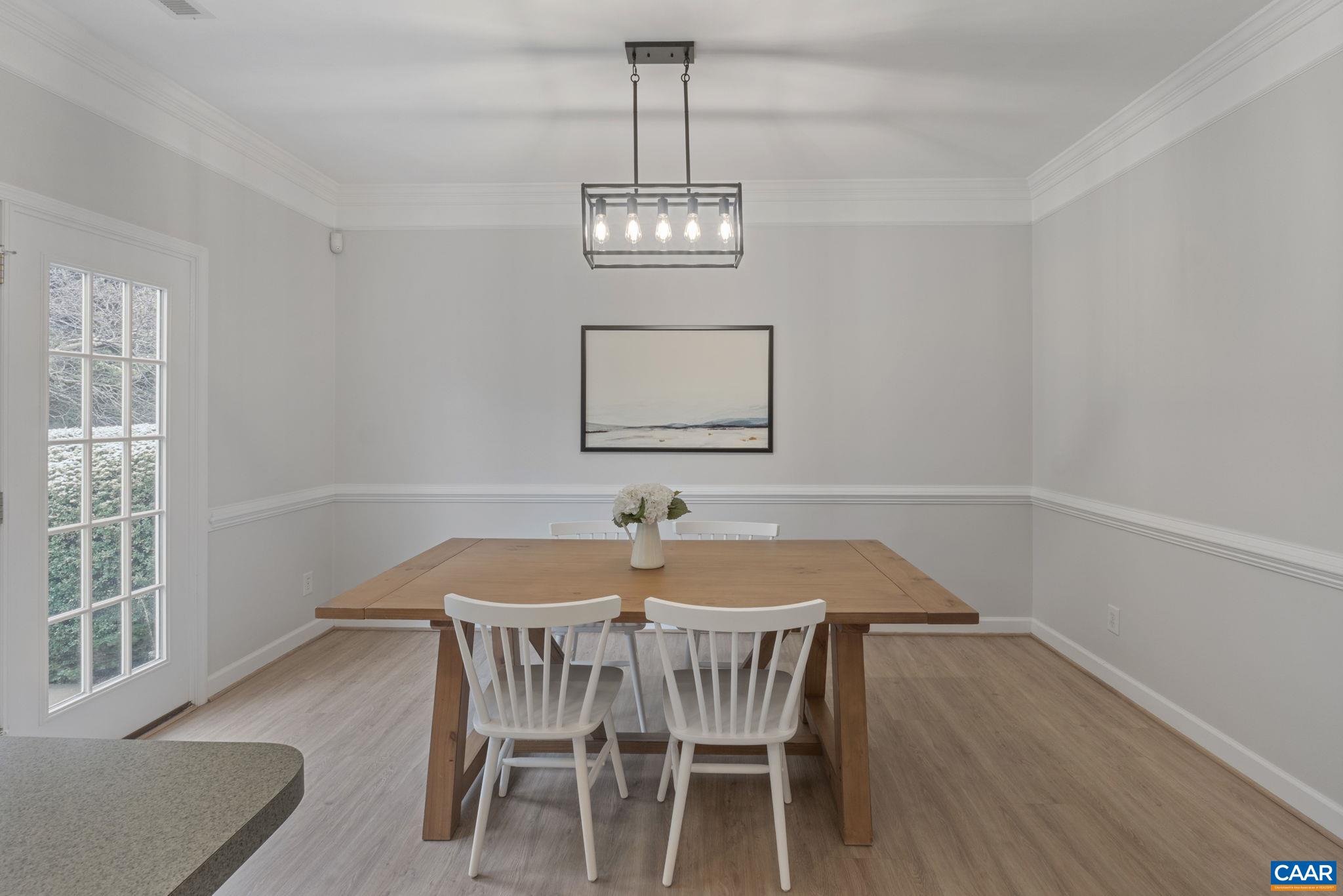 Modern light fixture and detailed trim with double-crown molding & chair rail Modern light fixture and detailed trim with double-crown molding & chair rail