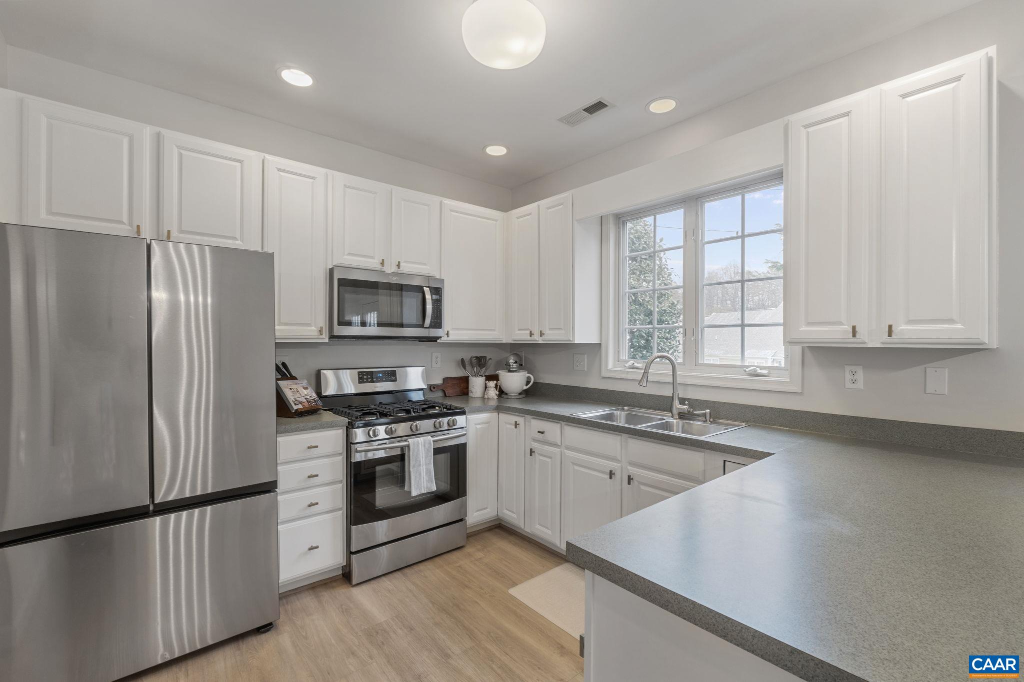 White cabinetry, newer Stainless French door refrigerator with auto-fill water pitcher White cabinetry, newer Stainless French door refrigerator with auto-fill water pitcher