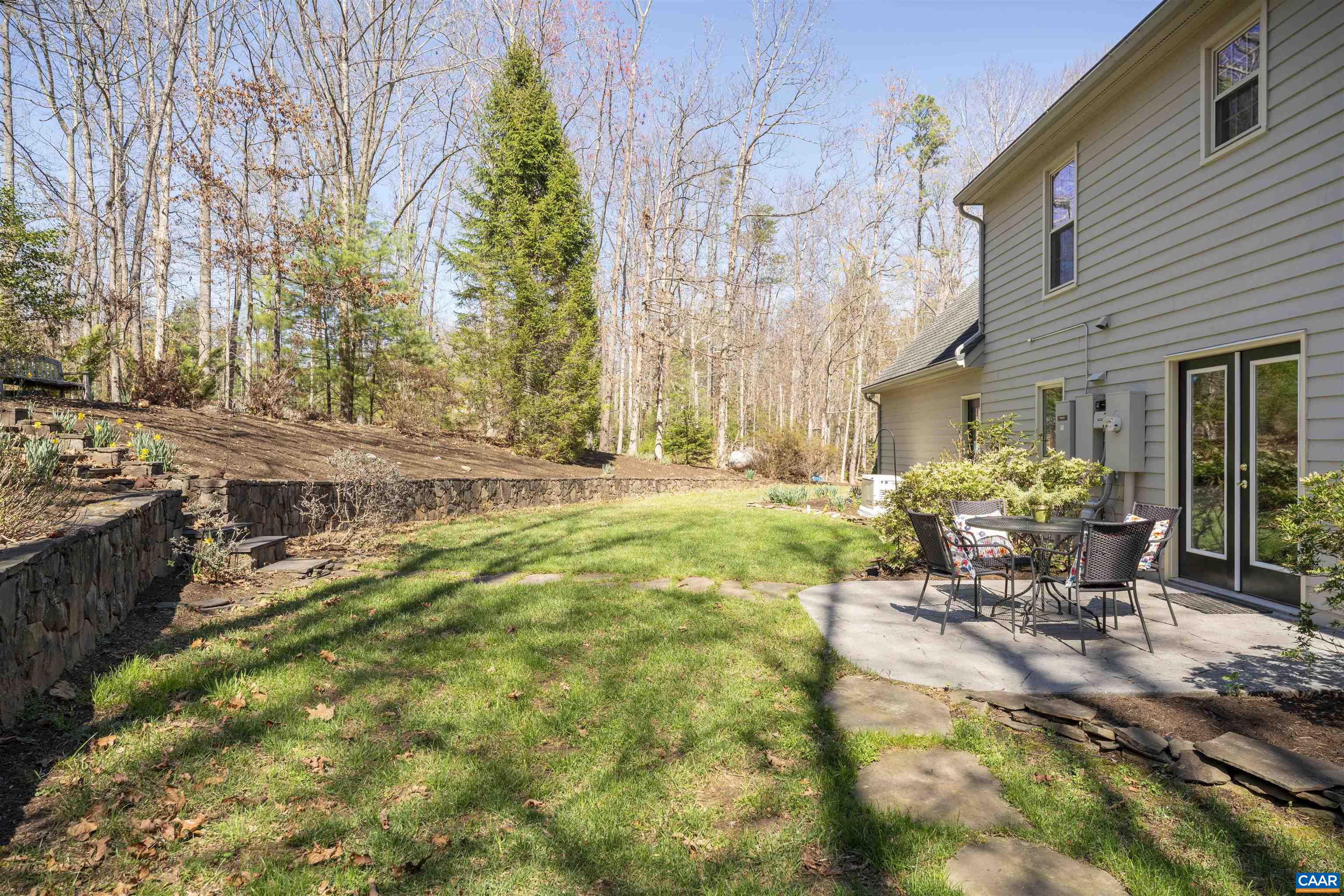 with stone wall, level lawn, lush perennials with stone wall, level lawn, lush perennials