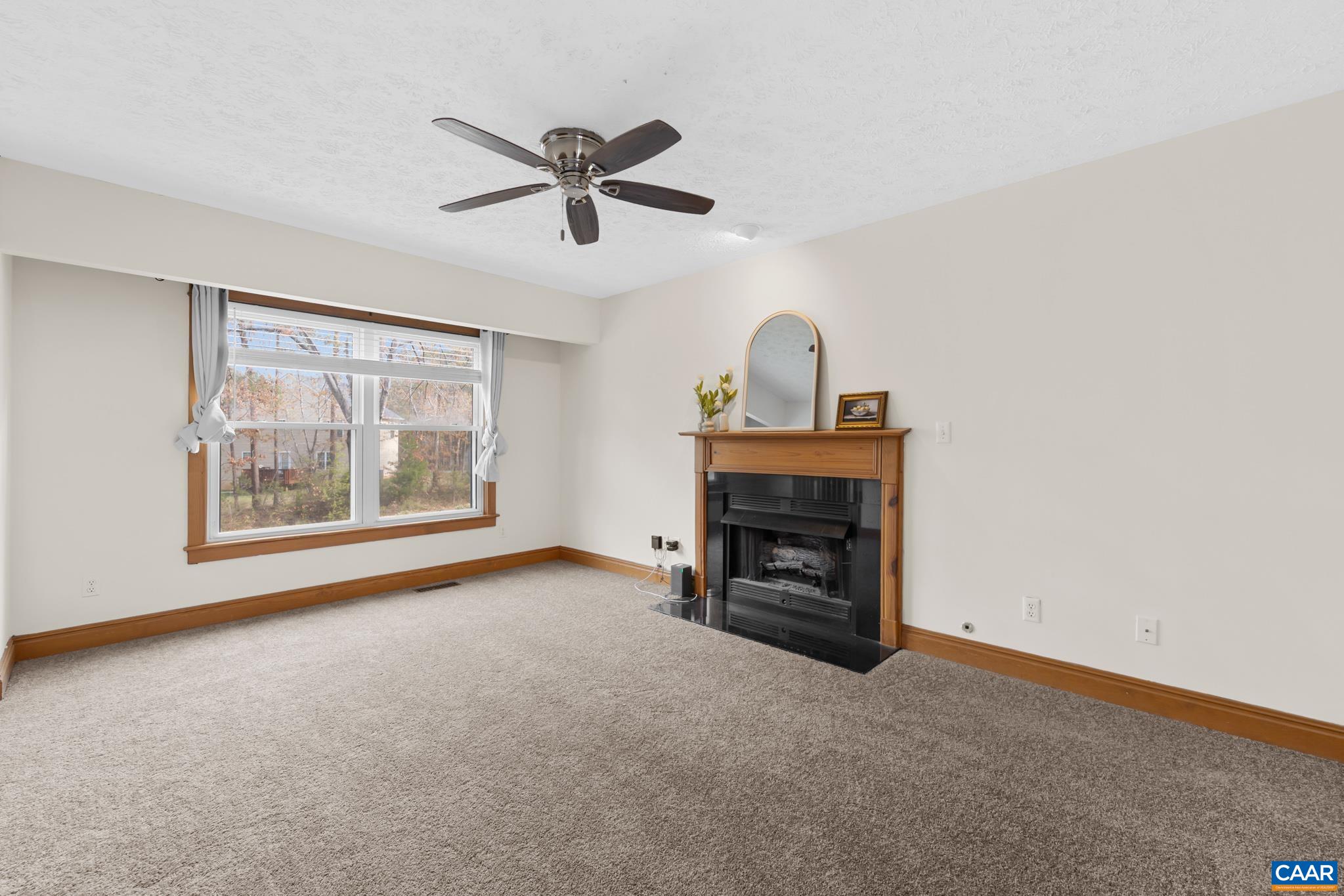 Cozy family room featuring a gas fireplace with gas logs and fresh new carpeting. Cozy family room featuring a gas fireplace with gas logs and fresh new carpeting.