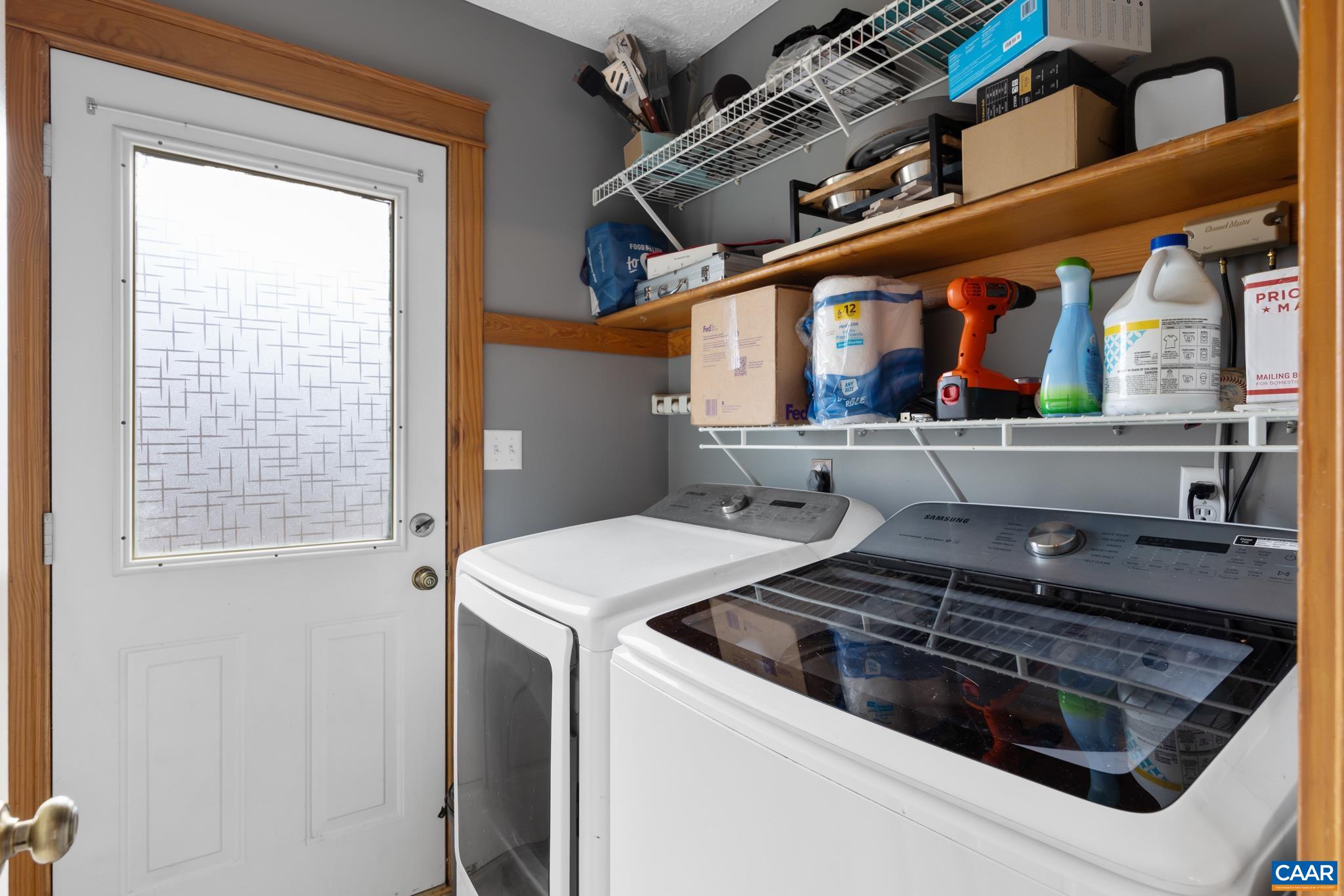 Main-level laundry room equipped with a washer and dryer included with the property. Main-level laundry room equipped with a washer and dryer included with the property.