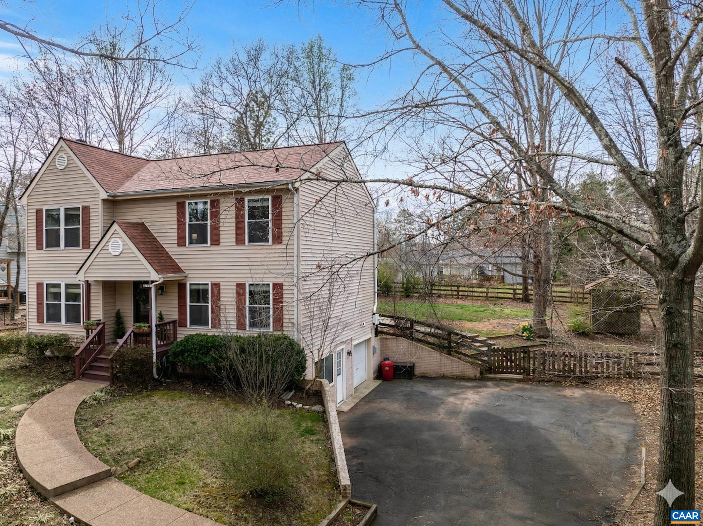 Attached side-loading garage and paved driveway with direct access to the walk-out basement. Attached side-loading garage and paved driveway with direct access to the walk-out basement.