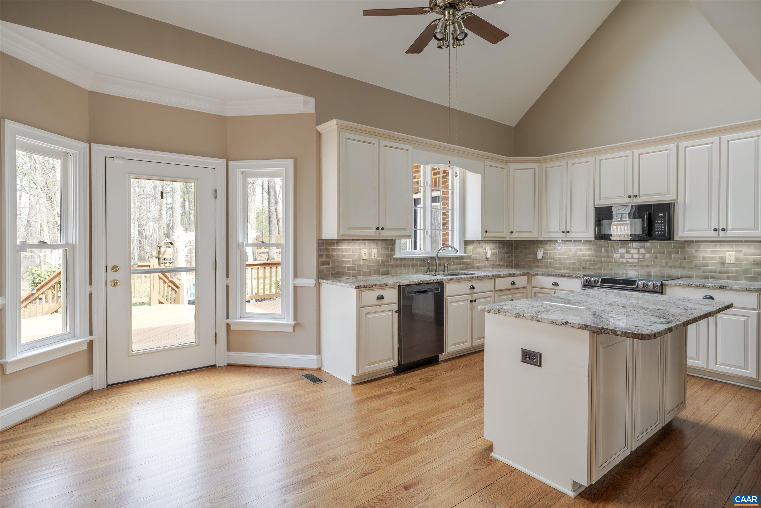 Eat-in kitchen with central island, granite counter tops with direct access onto the rear deck. Eat-in kitchen with central island, granite counter tops with direct access onto the rear deck.