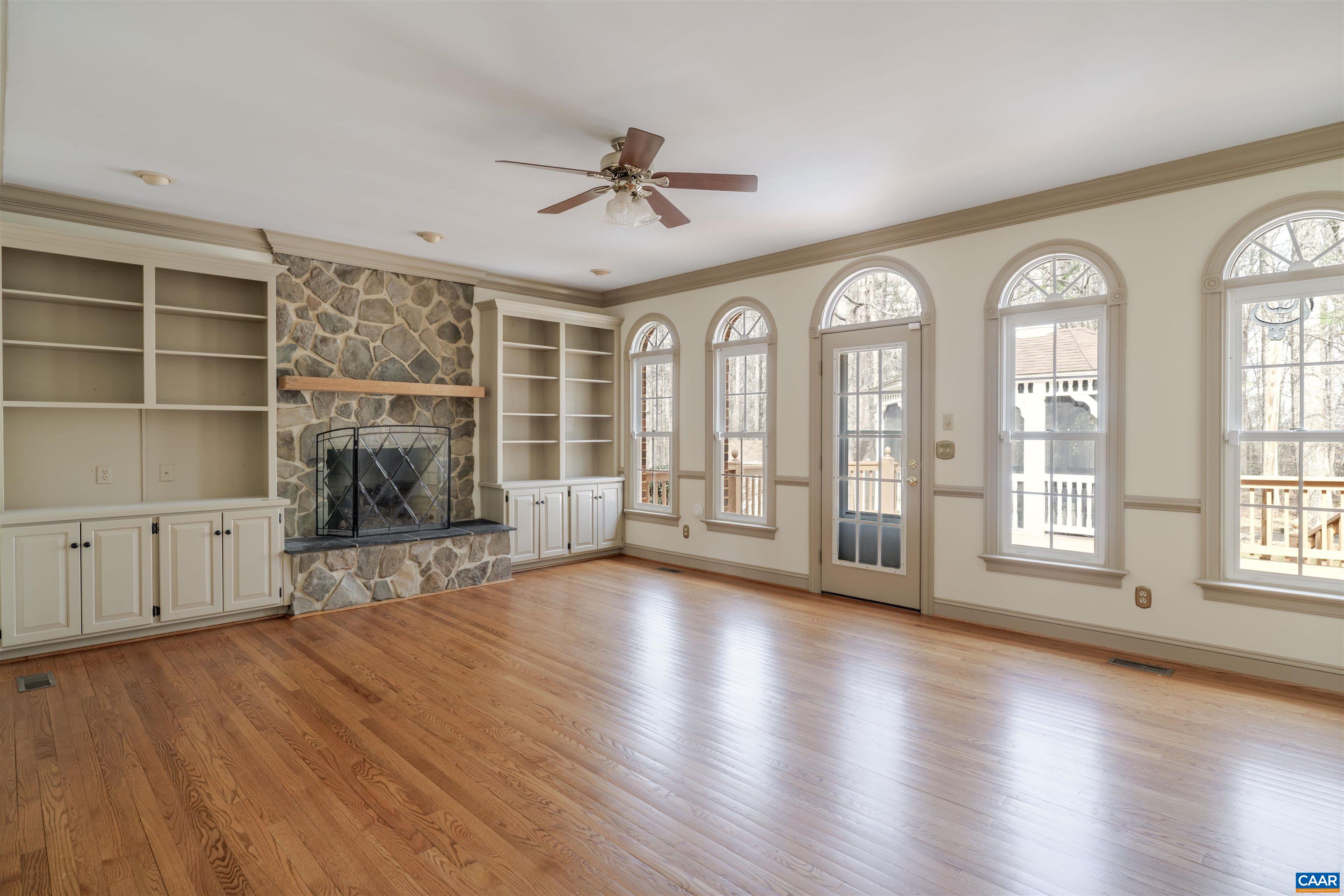 Large Family Room with gas fireplace that leads to the rear deck & screened porch. Large Family Room with gas fireplace that leads to the rear deck & screened porch.