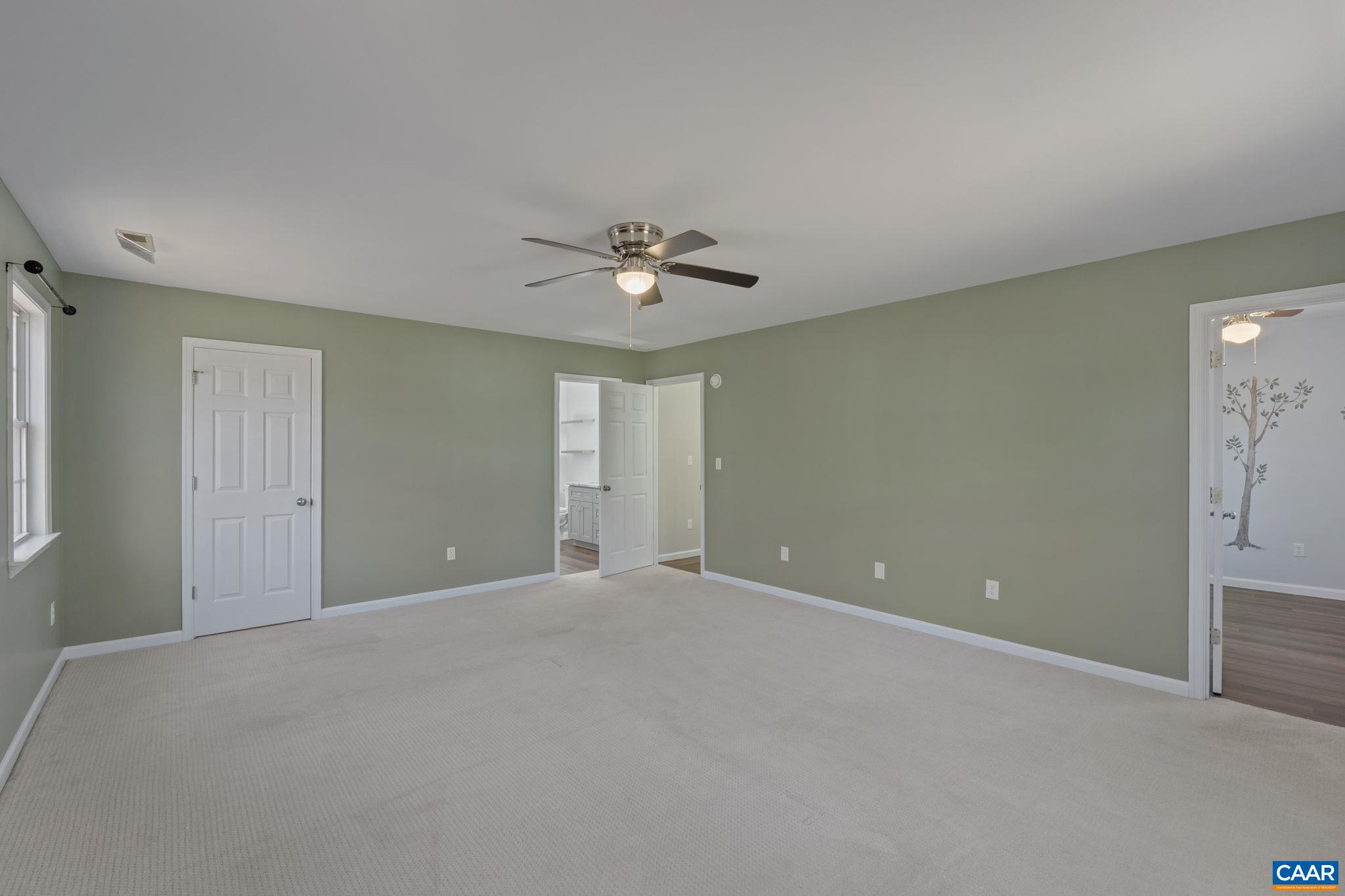 The spacious primary bedroom features ample space for a king size bed along with sitting room, walk-in closet and attached bath.